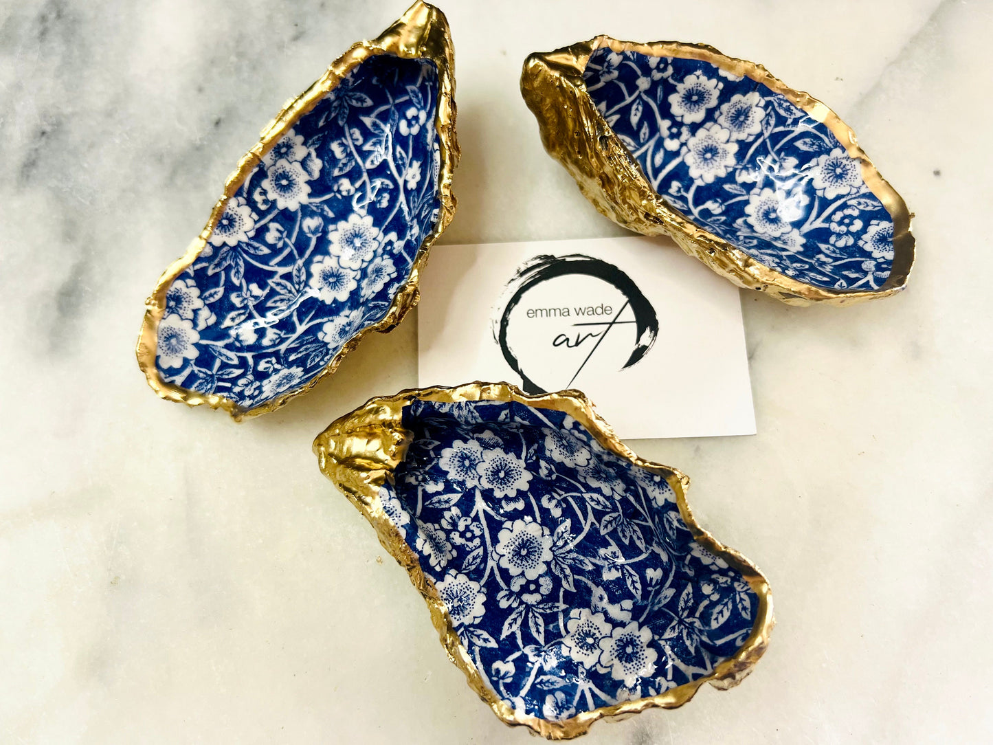navy blue and white floral oyster shell dish, Dorset oyster shell jewellery holder, handmade coastal trinket dish UK, gold leaf gilded oyster shell ornament, eco friendly oyster shell vanity tray, unique handmade oyster shell cufflink or tie pin dish, navy floral oyster shell salt and pepper pinch pot, oyster shell spoon rest or sugar dish, floral oyster shell coastal bathroom accessory, sustainable Dorset oyster shell art, handmade oyster shell wedding or anniversary gift UK