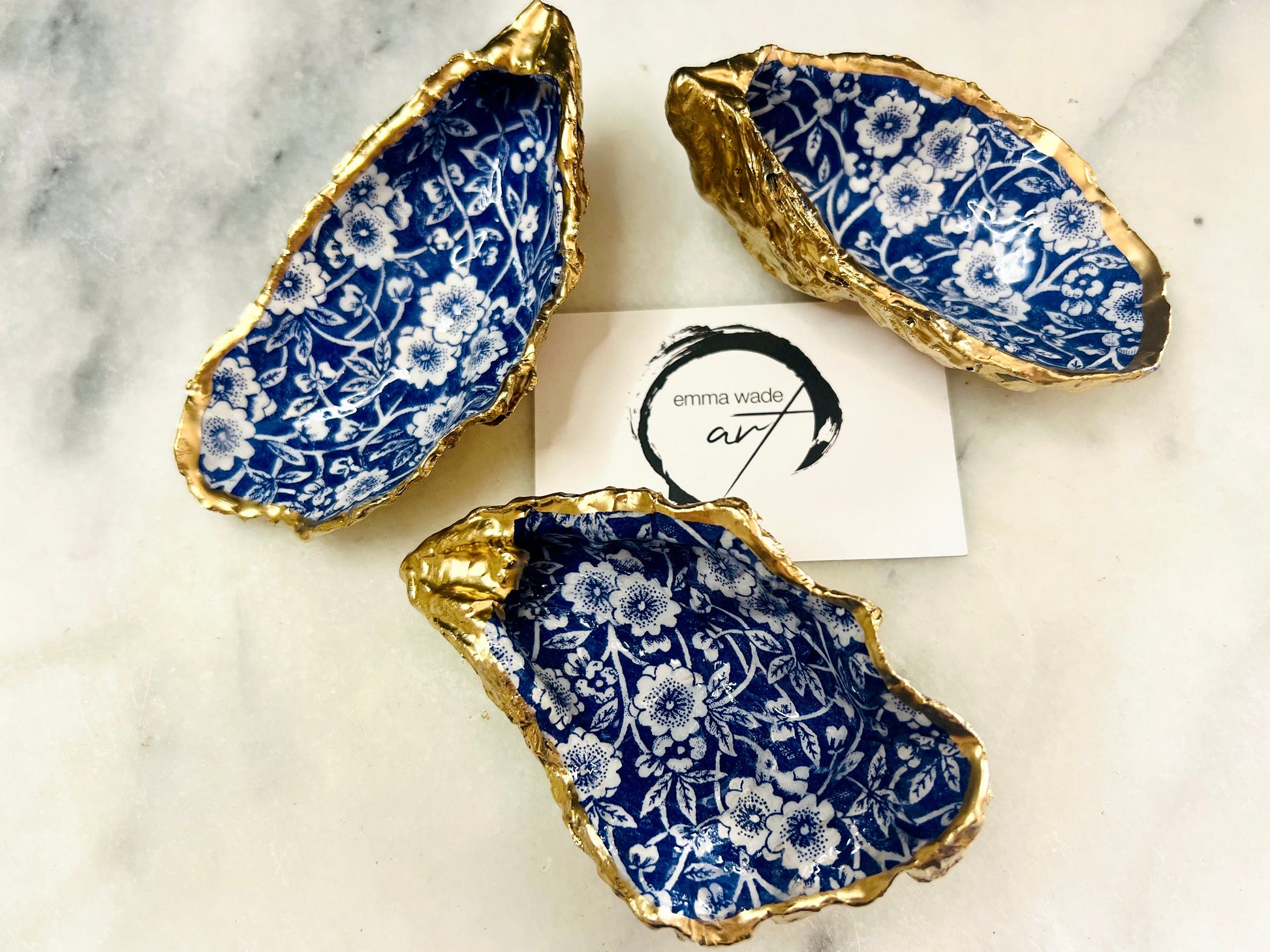 navy blue and white floral oyster shell dish, Dorset oyster shell jewellery holder, handmade coastal trinket dish UK, gold leaf gilded oyster shell ornament, eco friendly oyster shell vanity tray, unique handmade oyster shell cufflink or tie pin dish, navy floral oyster shell salt and pepper pinch pot, oyster shell spoon rest or sugar dish, floral oyster shell coastal bathroom accessory, sustainable Dorset oyster shell art, handmade oyster shell wedding or anniversary gift UK