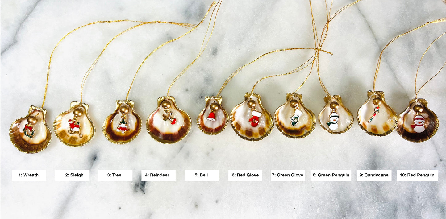 Handmade scallop shell Christmas ornaments with gold leaf edging and enamel charms, natural pearl shell decorations, Dorset shell baubles, festive tree decorations, stocking filler gifts, coastal Christmas decor, small hanging ornaments with gold string, unique handmade shell keepsake, wreath sleigh tree reindeer bell penguin charms, luxury Christmas gift idea