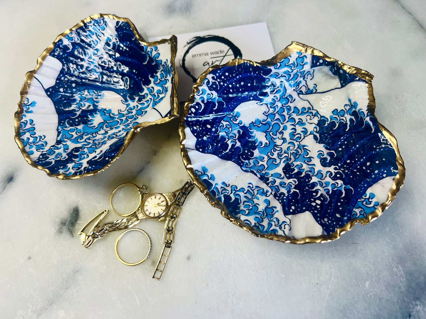 Great Wave of Kanagawa inspired scallop shell trinket dish with deep blue ocean wave artwork, gold leaf edging and glossy resin finish. Handmade coastal jewellery tray and Japanese ocean-inspired ring dish created from a natural Dorset scallop shell.