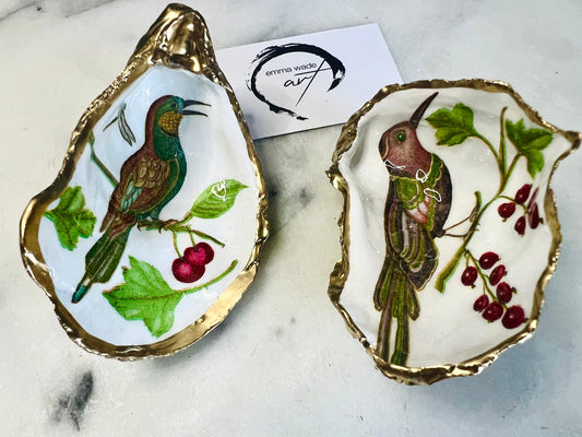 Handmade Dorset oyster shell trinket dish featuring Birds of Paradise illustration with green and brown bird designs, hand gilded with liquid gold leaf on the rim and reverse, sealed with glossy crystal clear resin, coastal jewellery holder, botanical bird decor, nature inspired oyster shell gift UK