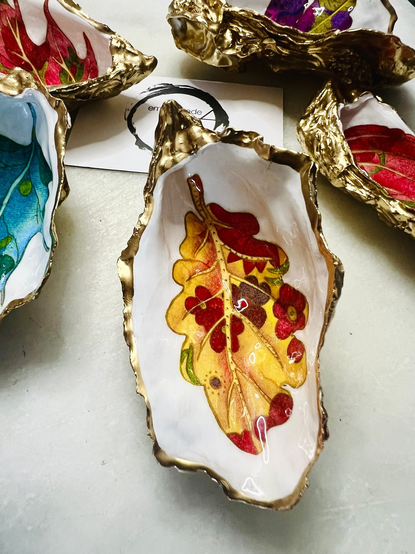 jewelled leaves oyster shell dish, Dorset oyster shell jewellery holder, gold leaf gilded oyster shell trinket dish, handmade coastal oyster shell decor, eco friendly oyster shell art UK, oyster shell bathroom tray, oyster shell salt and pepper pinch pot, leaf design oyster shell ornament, red leaf oyster shell, yellow leaf oyster shell, multiple designs available oyster shell dish, unique oyster shell keepsake, sustainable oyster shell jewellery tray, handmade Dorset shell gift