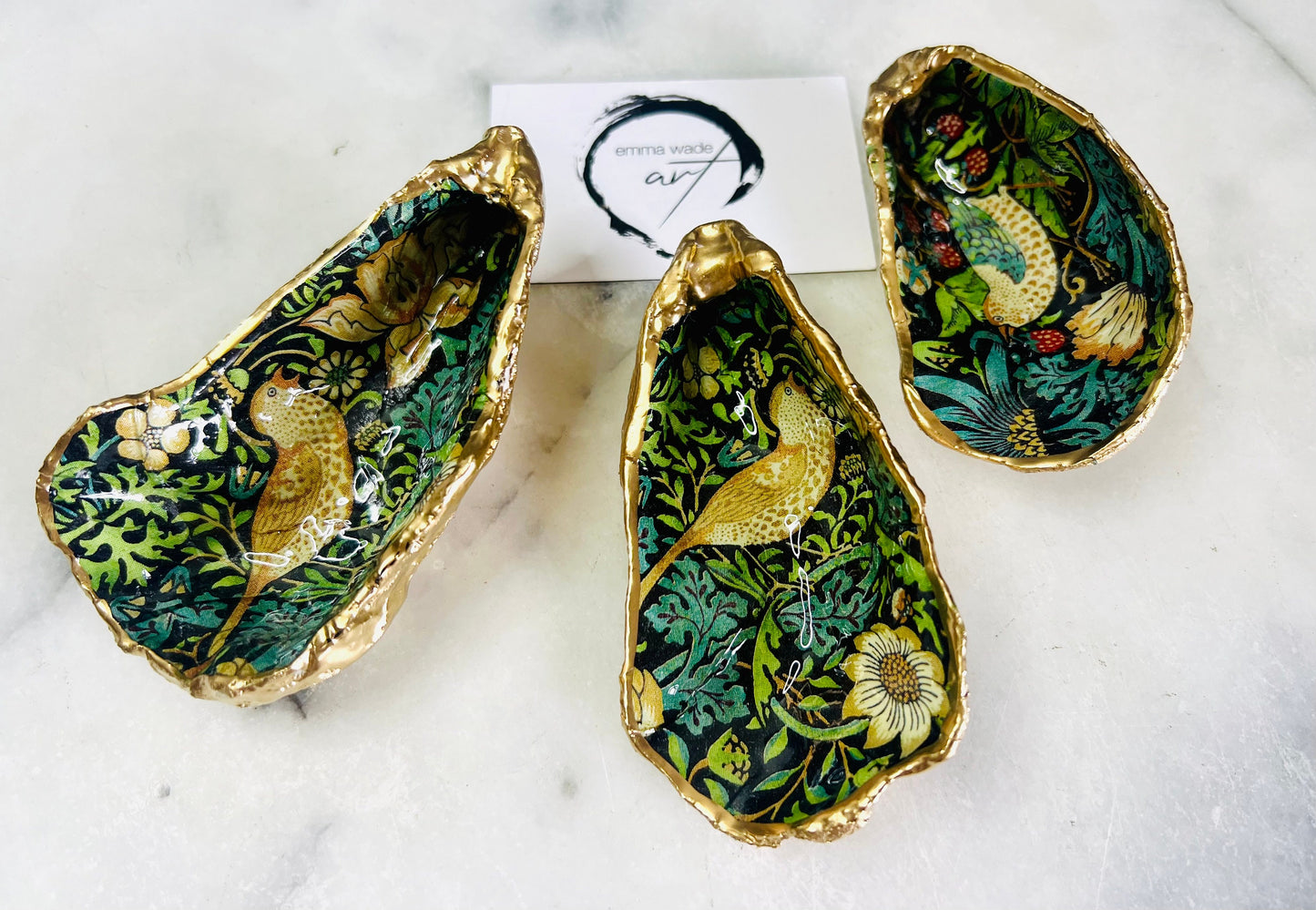 Handcrafted William Morris Strawberry Thief oyster shell dish. Gilded with real gold leaf and finished with glossy resin. Two designs available. Ideal as a jewellery dish, trinket holder, cufflink or tie pin dish, tea light holder, or salt and pepper pinch pot. Sustainable coastal décor, UK handmade shell ornament, unique gift for weddings, birthdays, anniversaries, or Christmas.