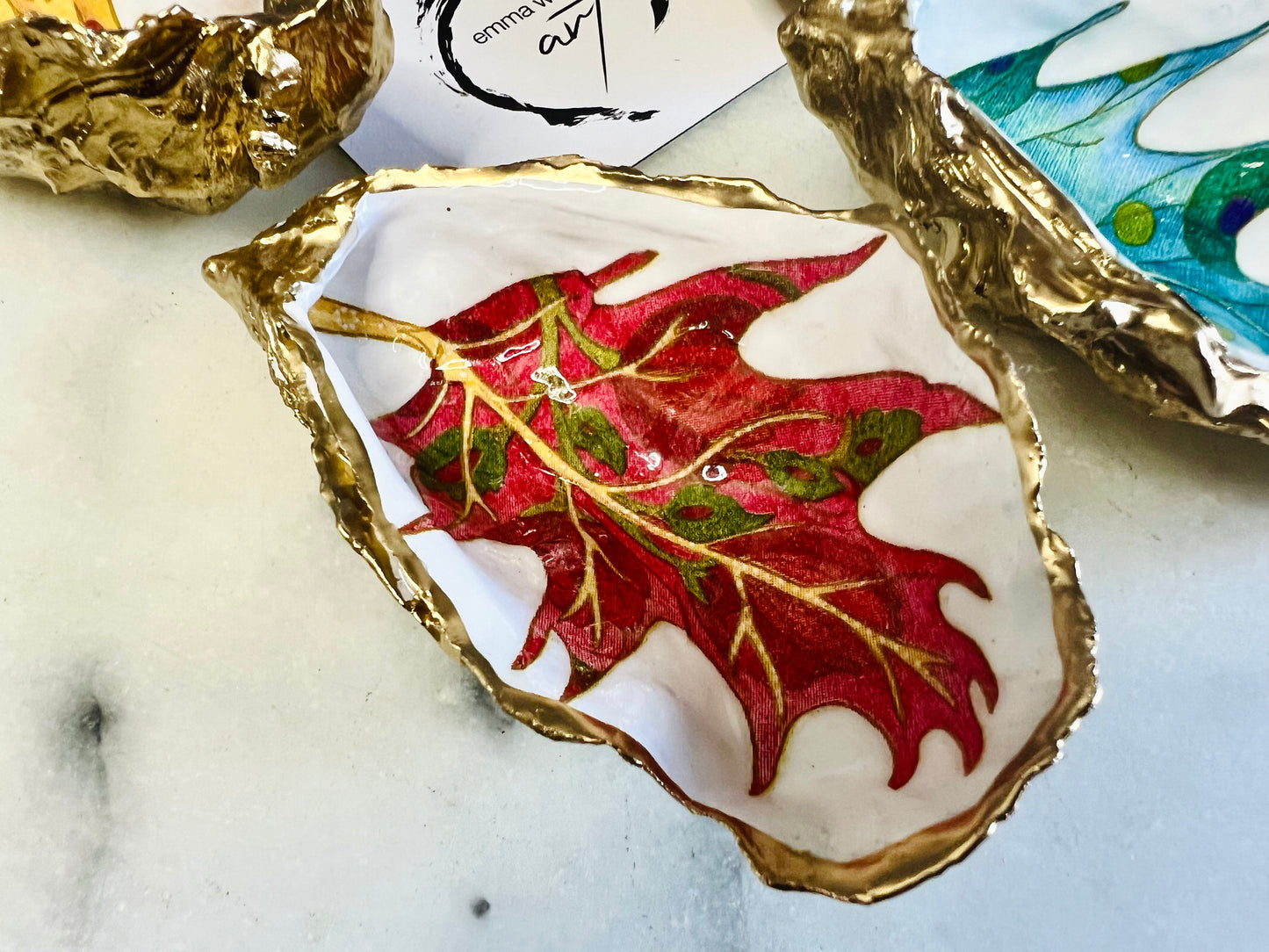 jewelled leaves oyster shell dish, Dorset oyster shell jewellery holder, gold leaf gilded oyster shell trinket dish, handmade coastal oyster shell decor, eco friendly oyster shell art UK, oyster shell bathroom tray, oyster shell salt and pepper pinch pot, leaf design oyster shell ornament, red leaf oyster shell, yellow leaf oyster shell, multiple designs available oyster shell dish, unique oyster shell keepsake, sustainable oyster shell jewellery tray, handmade Dorset shell gift