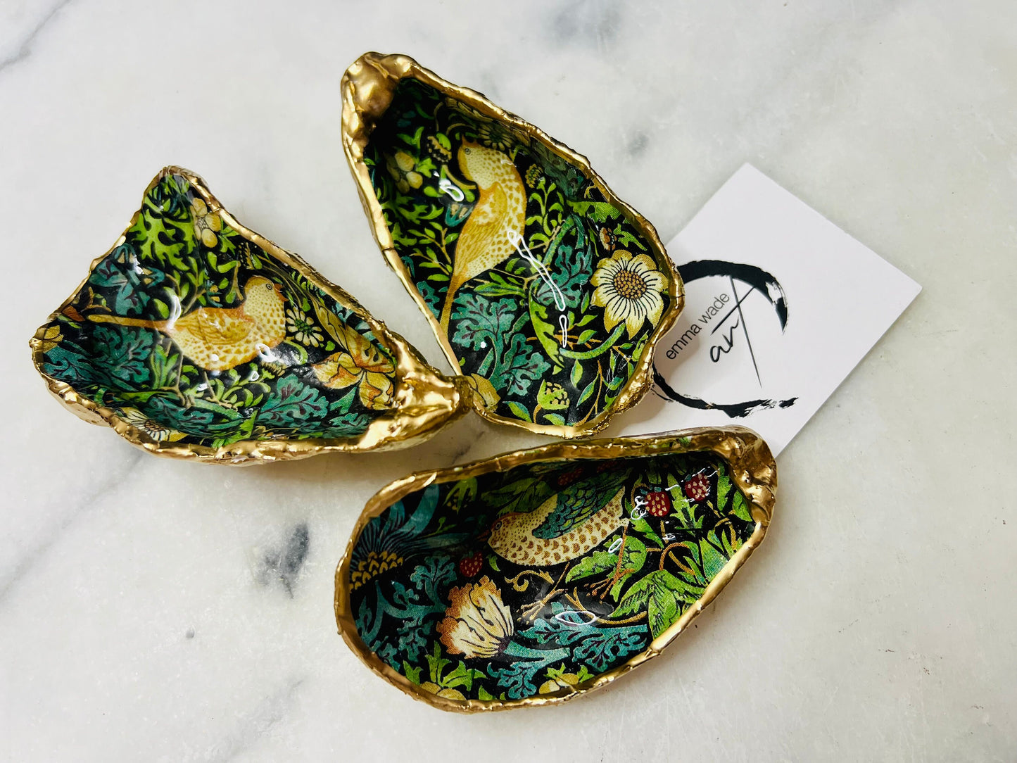 Handcrafted William Morris Strawberry Thief oyster shell dish. Gilded with real gold leaf and finished with glossy resin. Two designs available. Ideal as a jewellery dish, trinket holder, cufflink or tie pin dish, tea light holder, or salt and pepper pinch pot. Sustainable coastal décor, UK handmade shell ornament, unique gift for weddings, birthdays, anniversaries, or Christmas.
