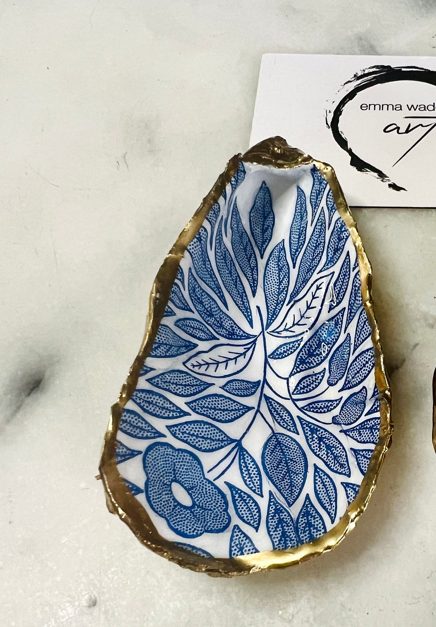 Blue flowers oyster shell trinket dish, Dorset oyster shell gift, gold leaf jewellery holder, handmade coastal decor, nautical bathroom dish, oyster shell ring holder, floral seashell trinket bowl, beach wedding favour, ocean inspired salt pinch pot, eco friendly shell gift, oyster shell spoon rest, seaside home accessory, handmade UK oyster shell dish, coastal jewellery organiser, blue floral oyster shell ornament.