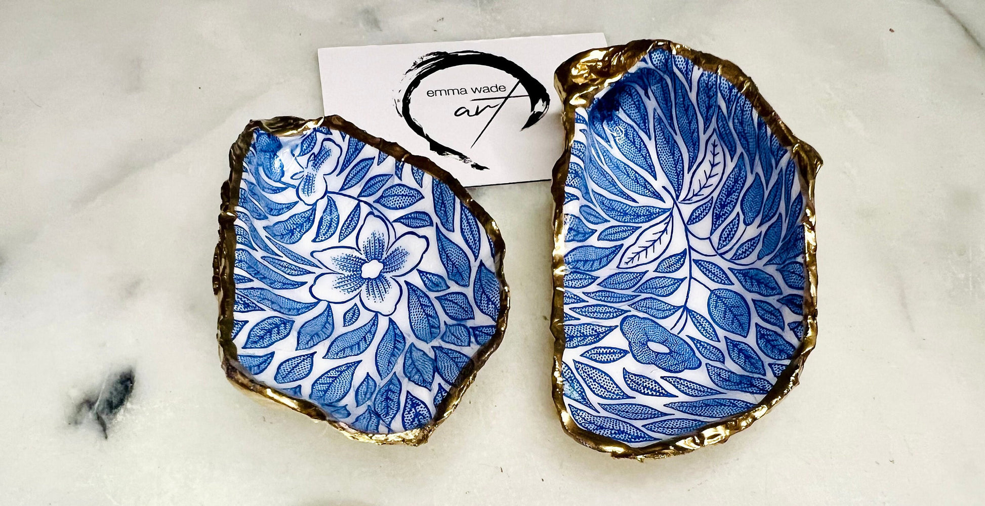 Blue flowers oyster shell trinket dish, Dorset oyster shell gift, gold leaf jewellery holder, handmade coastal decor, nautical bathroom dish, oyster shell ring holder, floral seashell trinket bowl, beach wedding favour, ocean inspired salt pinch pot, eco friendly shell gift, oyster shell spoon rest, seaside home accessory, handmade UK oyster shell dish, coastal jewellery organiser, blue floral oyster shell ornament.