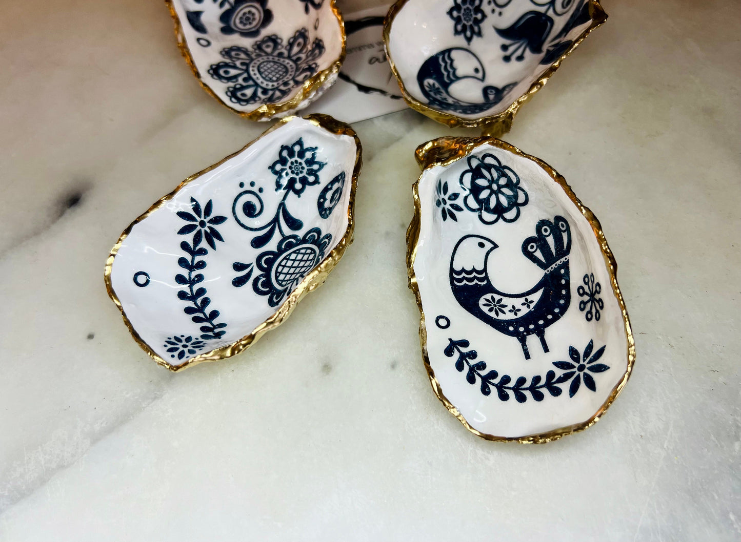 Marimekko flowers and birds oyster shell trinket dish, handmade coastal décor, Dorset shell jewellery holder, gold leaf gilded ornament, unique ocean-inspired gift, oyster shell ring dish, wedding favour, anniversary gift, handmade eco-friendly shell bowl, nautical bathroom accessory, salt and pepper pinch pot, tea light holder, sustainable oyster shell art, luxury coastal tableware, perfect gift for nature and design lovers.