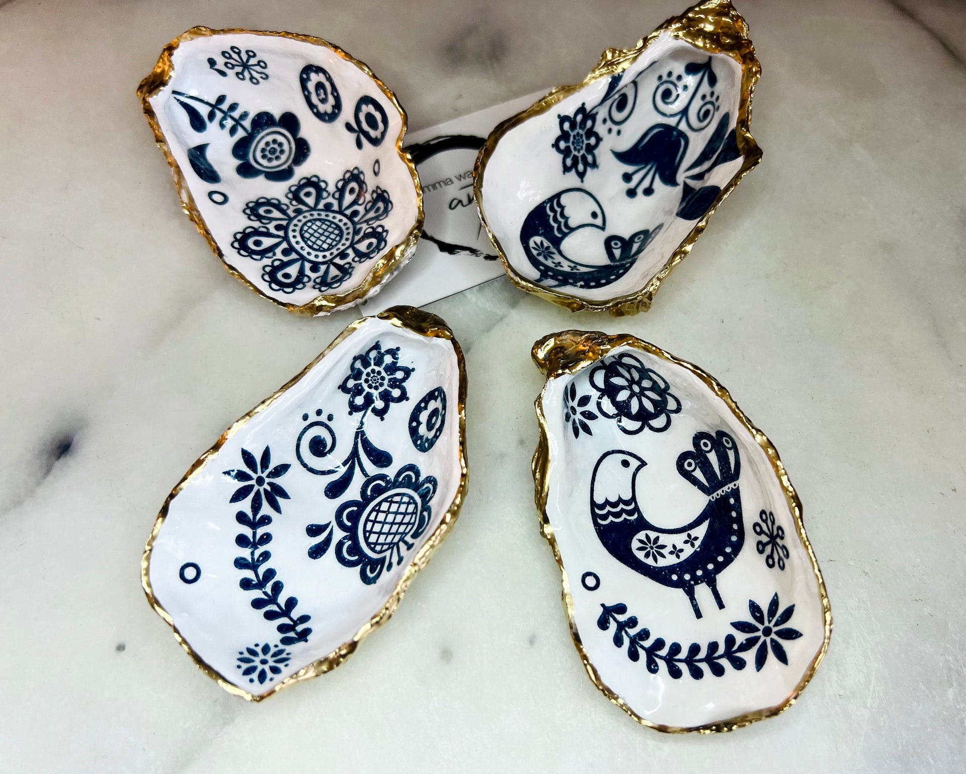 Marimekko flowers and birds oyster shell trinket dish, handmade coastal décor, Dorset shell jewellery holder, gold leaf gilded ornament, unique ocean-inspired gift, oyster shell ring dish, wedding favour, anniversary gift, handmade eco-friendly shell bowl, nautical bathroom accessory, salt and pepper pinch pot, tea light holder, sustainable oyster shell art, luxury coastal tableware, perfect gift for nature and design lovers.