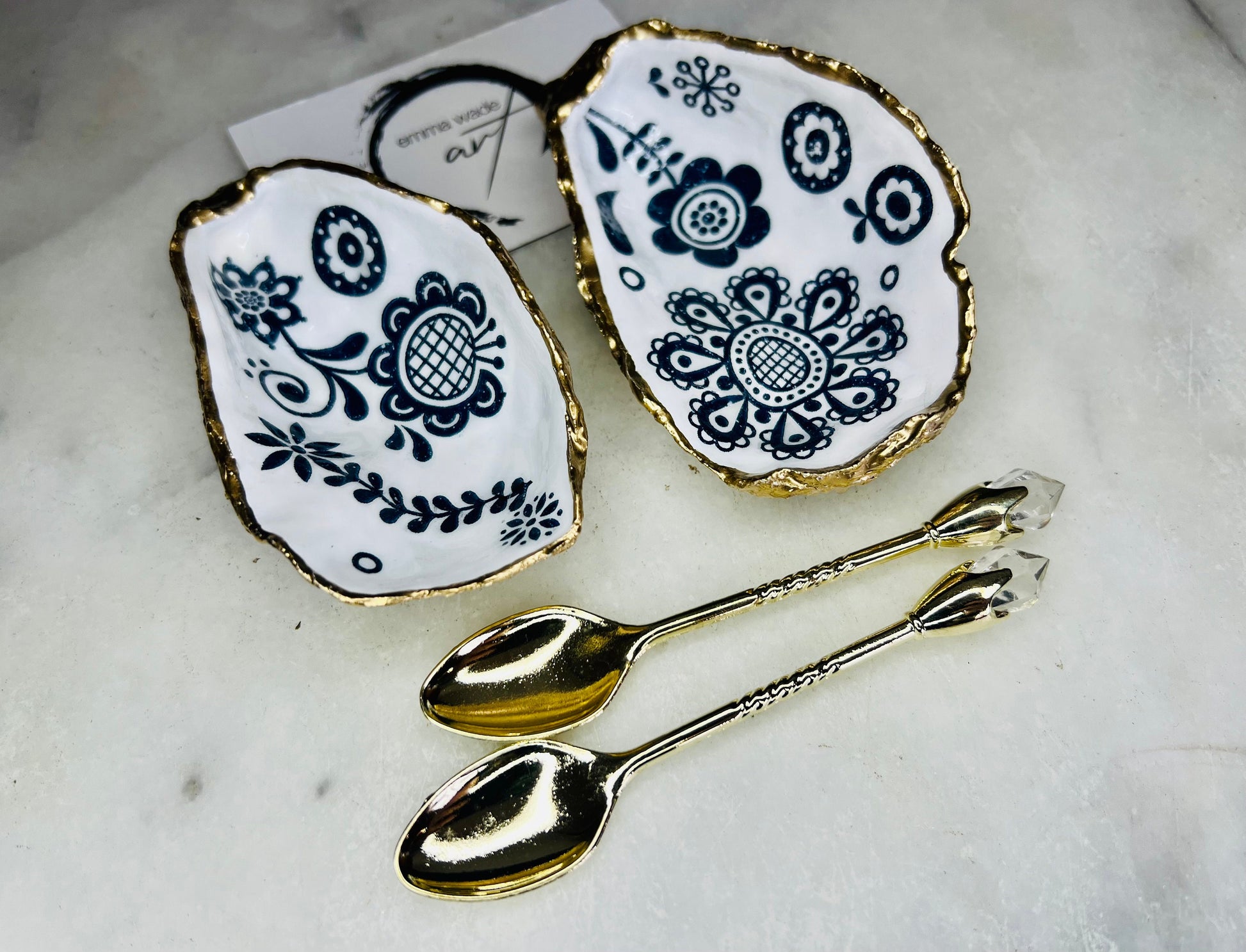 Marimekko style oyster shell salt & pepper pinch pots, Finnish design inspired blue floral and bird cruet dishes, UK handmade salt gift set. Pair of Dorset oyster shells, sealed with food-safe resin and finished with gold leaf edges, perfect for wedding table décor, anniversary gifts, dinner party tableware or unique coastal home décor. Sustainable handmade salt pots with optional gold crystal spoons for a luxury finishing touch.
