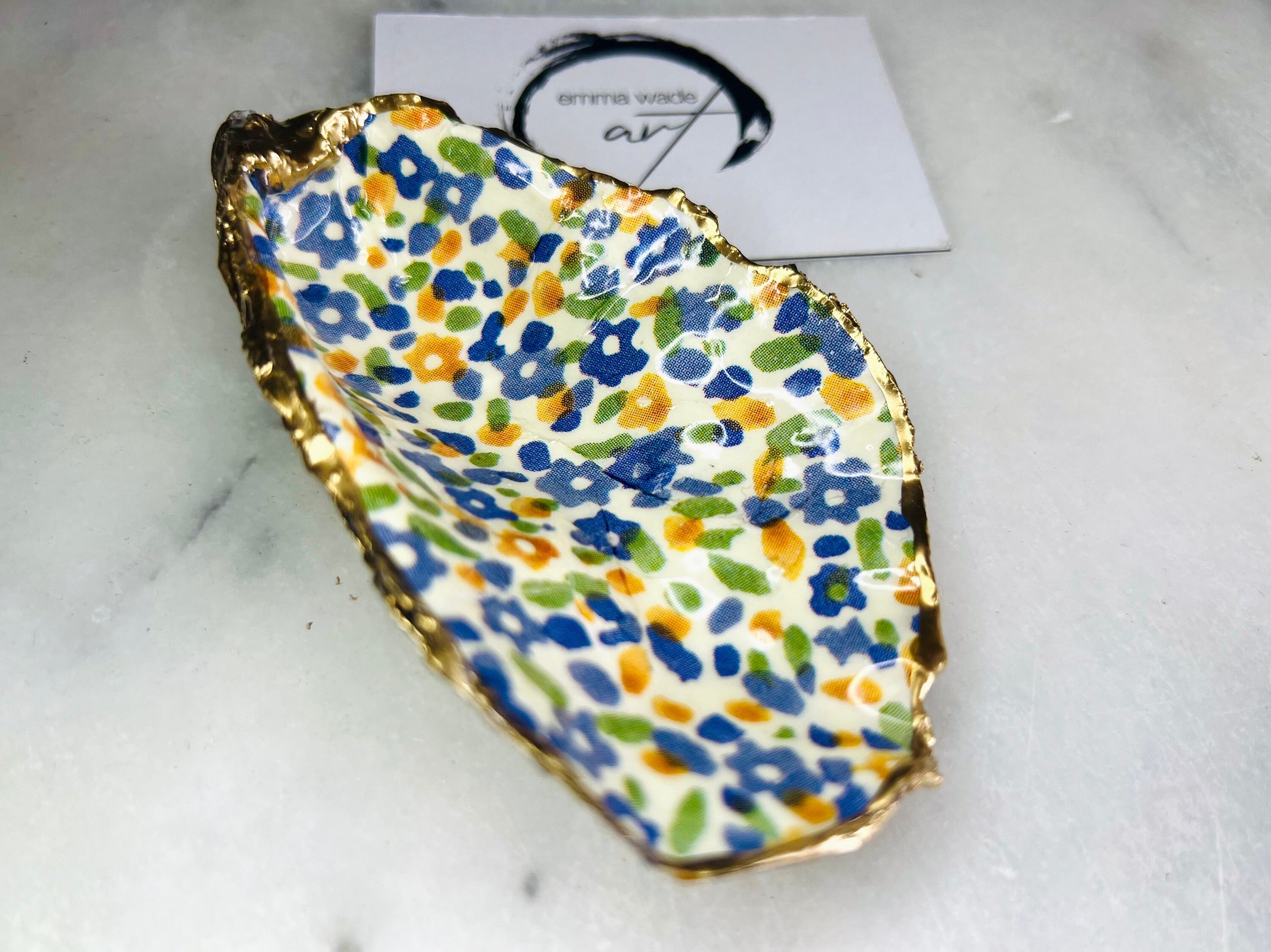 jewellery shell dish, gift for her, gift for mum, ring carrier dish, coastal decor, shell Decor, EmmaWadeART, Handmade Dorset oyster shell dish featuring Emma Bridgewater Yellow Blue Wildflower Meadow design. Finished with real gold leaf and resin. Use as a shell jewellery holder, ring dish, trinket tray, shell tray, salt pinch pot, tea light holder, or Christmas ornament. Sustainable coastal décor and unique handmade UK gift for weddings, anniversaries, or festive occasions.