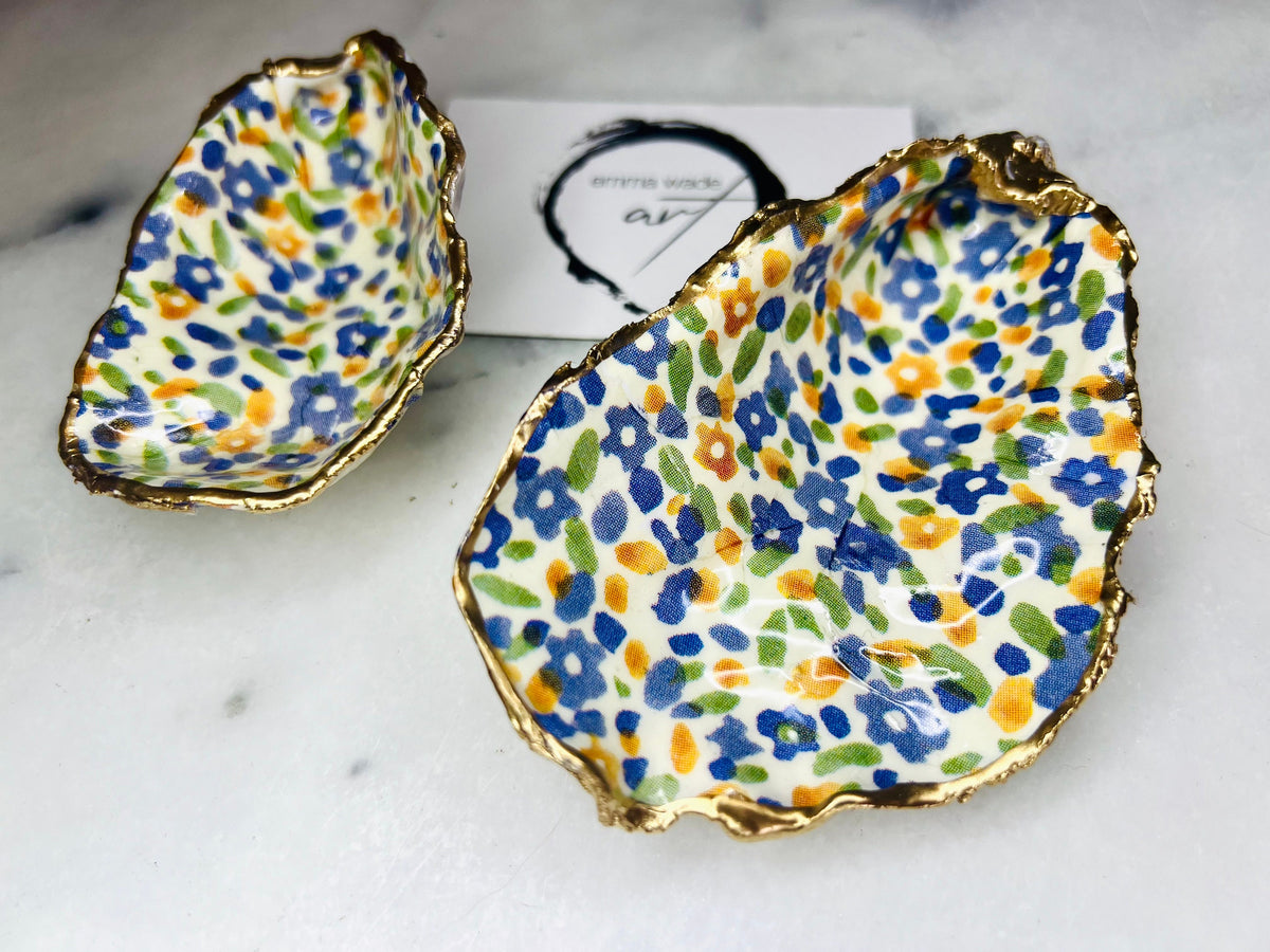 Handmade Dorset oyster shell dish featuring Emma Bridgewater Yellow Blue Wildflower Meadow design. Finished with real gold leaf and resin. Use as a jewellery holder, ring dish, trinket tray, shell tray, salt pinch pot, tea light holder, or Christmas ornament. Sustainable coastal décor and unique handmade UK gift for weddings, anniversaries, birthdays, Mother’s Day, or festive occasions.