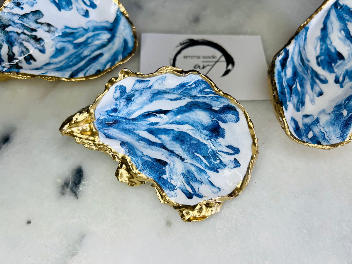Trinket dishes gold finish, shell jewellery dish, navy and gold trinket tray, shell scallop dish, trinket tray shell, she dreams of the sea, shell jewellery bowl, golden trinket dish, oyster shell blue seaweed, blue and gold dishes, decoupaged earring dish, oyster dish with coral, shell art trinket, decoupage shell dish, Emma Wade art, bride oyster dish, oyster shell trinket, shell key bowl, shell coral dish