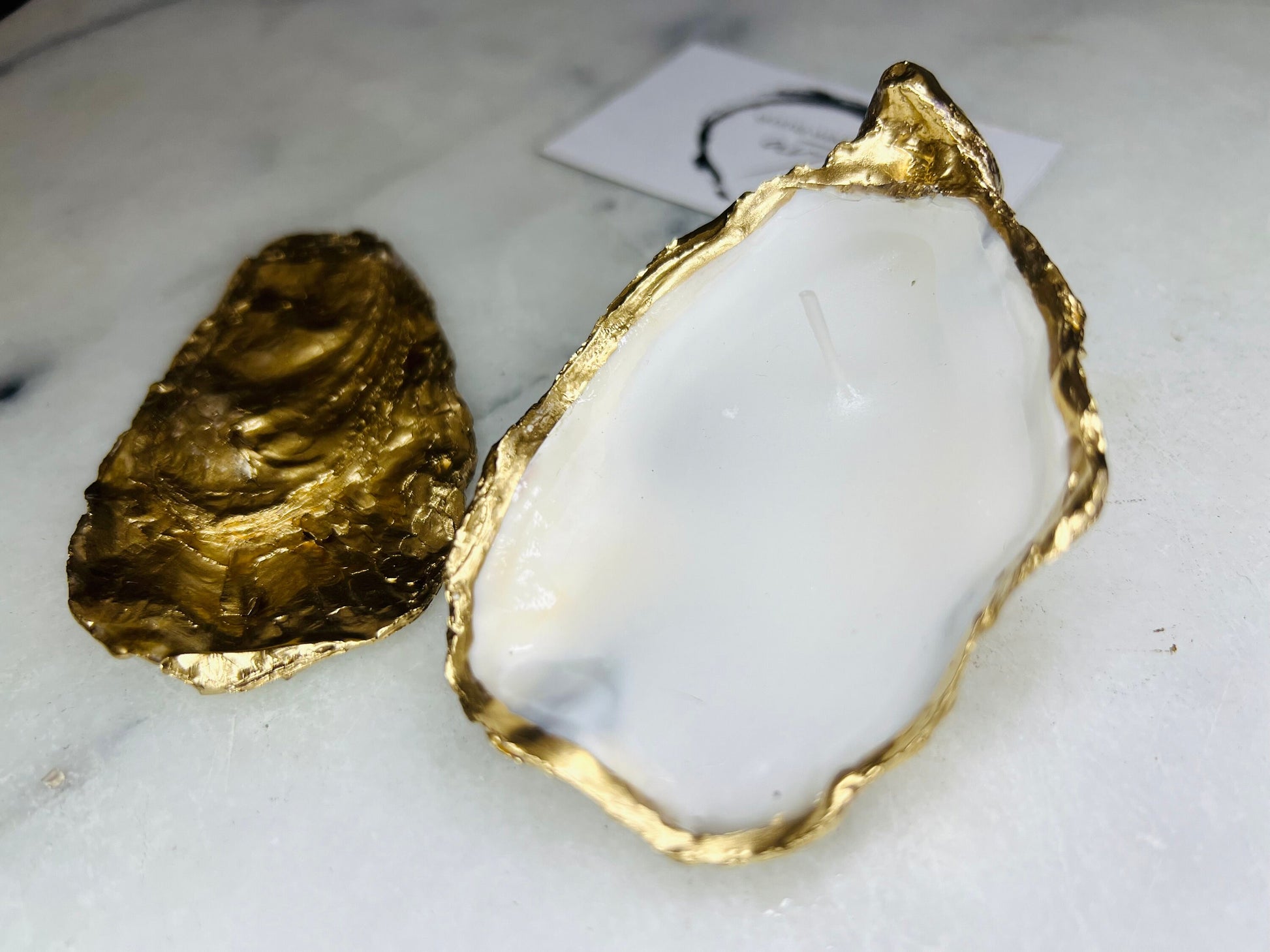 oyster shell candle, gold oyster candle, gilded oyster shells, hand poured candle, coastal decor, ocean inspired candle, beach home decor, sustainable candle, handmade in Surrey, luxury shell candle, sea lover gift, oyster shell pair, artisan candle, eco friendly candle, gold rim shell, nautical decor, ocean gift, coastal homeware, handmade oyster shell candle, shell wedding decor, seaside candle, mother of pearl shell, gold edged candle, beach cottage style, elegant coastal gift