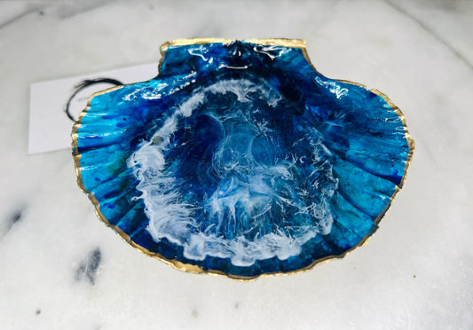 Extra large hand painted Dorset scallop shell dish inspired by ocean caves and sea grottos, featuring layered blue acrylic inks and crystal clear resin art with foaming wave details, hand gilded with liquid gold leaf on the rim and reverse, luxury coastal trinket dish, ocean inspired jewellery holder, handmade resin shell decor UK