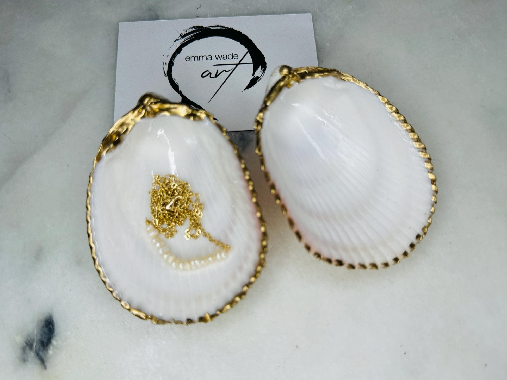 Handmade gold gilded cockle shell jewellery box with pearly white interior and optional freshwater pearl necklace. Coastal shell ring box crafted from natural Dorset shells, edged with liquid gold leaf and presented in a luxury gift box. Elegant seaside-inspired keepsake gift for weddings, bridesmaids, birthdays, anniversaries, or jewellery storage.