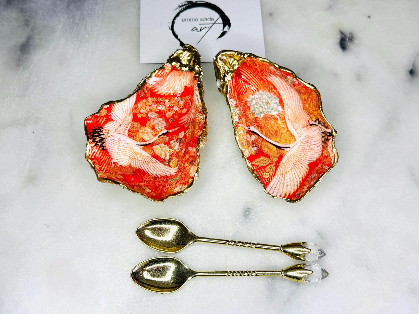 Handmade oyster shell cruet set with gold leaf trim. Salt and pepper pinch pots made from Dorset shells. Orange flamingo and Japanese kimono bird design. Sustainable and eco-friendly. A unique salt gift for weddings, anniversaries, housewarmings, or as a Christmas gift. Perfect for dinner parties, coastal home decor, or handmade UK tableware. Also ideal as spice pots, shell pots, or luxury gifts with optional gold crystal spoons.
