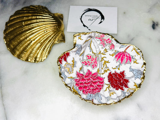 Handcrafted Dorset scallop shell trinket dish featuring William Morris Cray floral design in pink and red botanical patterns with hand gilded gold leaf edging and glossy resin finish. English cottage style jewellery dish and coastal heritage décor piece styled as a luxury shell tray.
