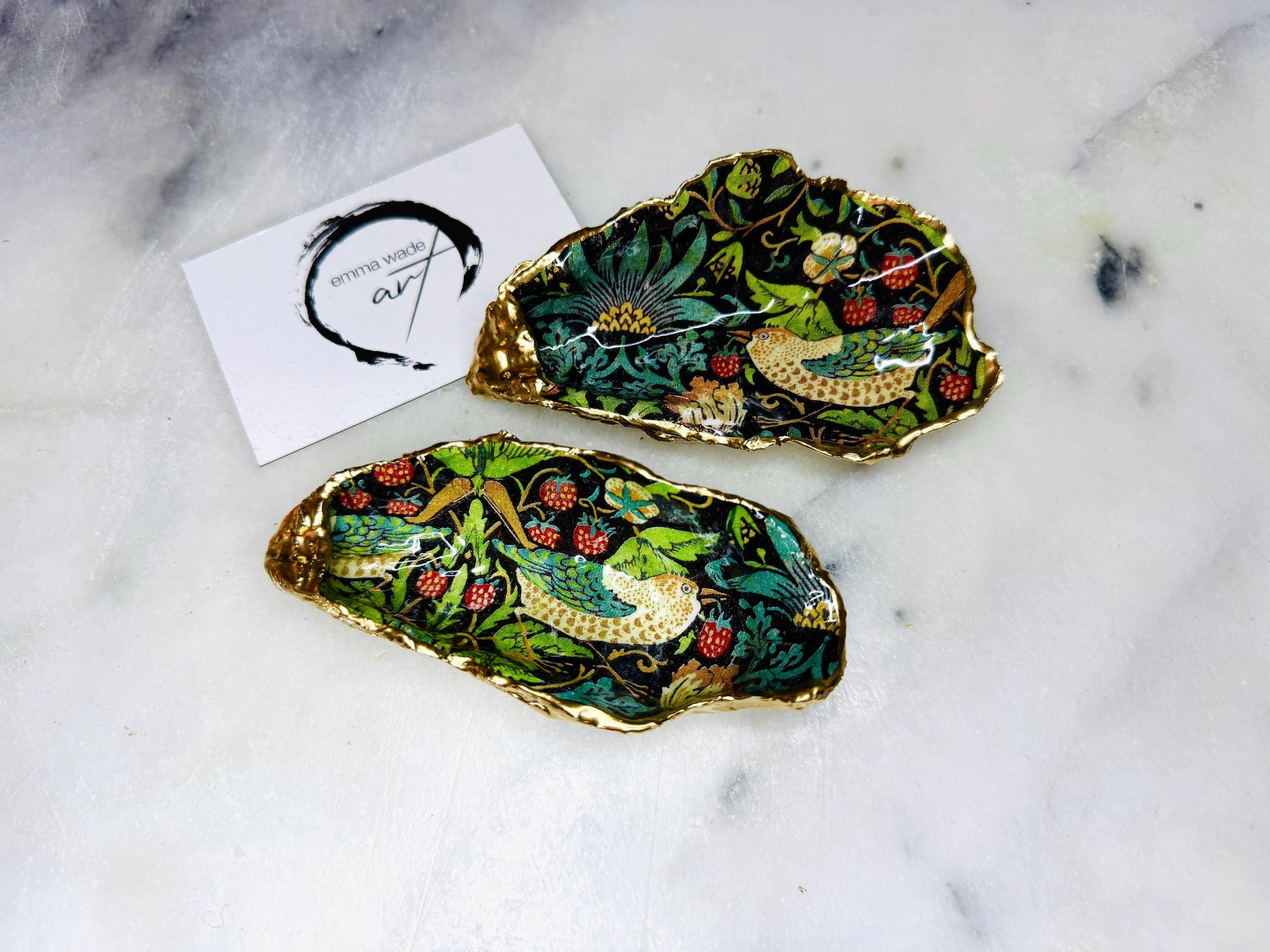 Handcrafted William Morris Strawberry Thief oyster shell dish. Gilded with real gold leaf and finished with glossy resin. Two designs available. Ideal as a jewellery dish, trinket holder, cufflink or tie pin dish, tea light holder, or salt and pepper pinch pot. Sustainable coastal décor, UK handmade shell ornament, unique gift for weddings, birthdays, anniversaries, or Christmas.
