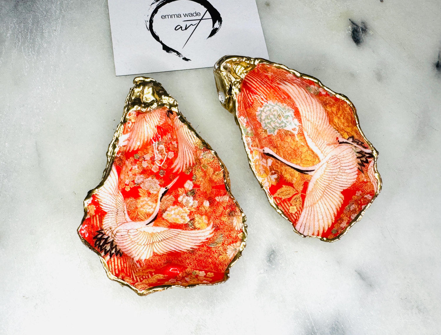 Handmade oyster shell cruet set with gold leaf trim. Salt and pepper pinch pots made from Dorset shells. Orange flamingo and Japanese kimono bird design. Sustainable and eco-friendly. A unique salt gift for weddings, anniversaries, housewarmings, or as a Christmas gift. Perfect for dinner parties, coastal home decor, or handmade UK tableware. Also ideal as spice pots, shell pots, or luxury gifts with optional gold crystal spoons.