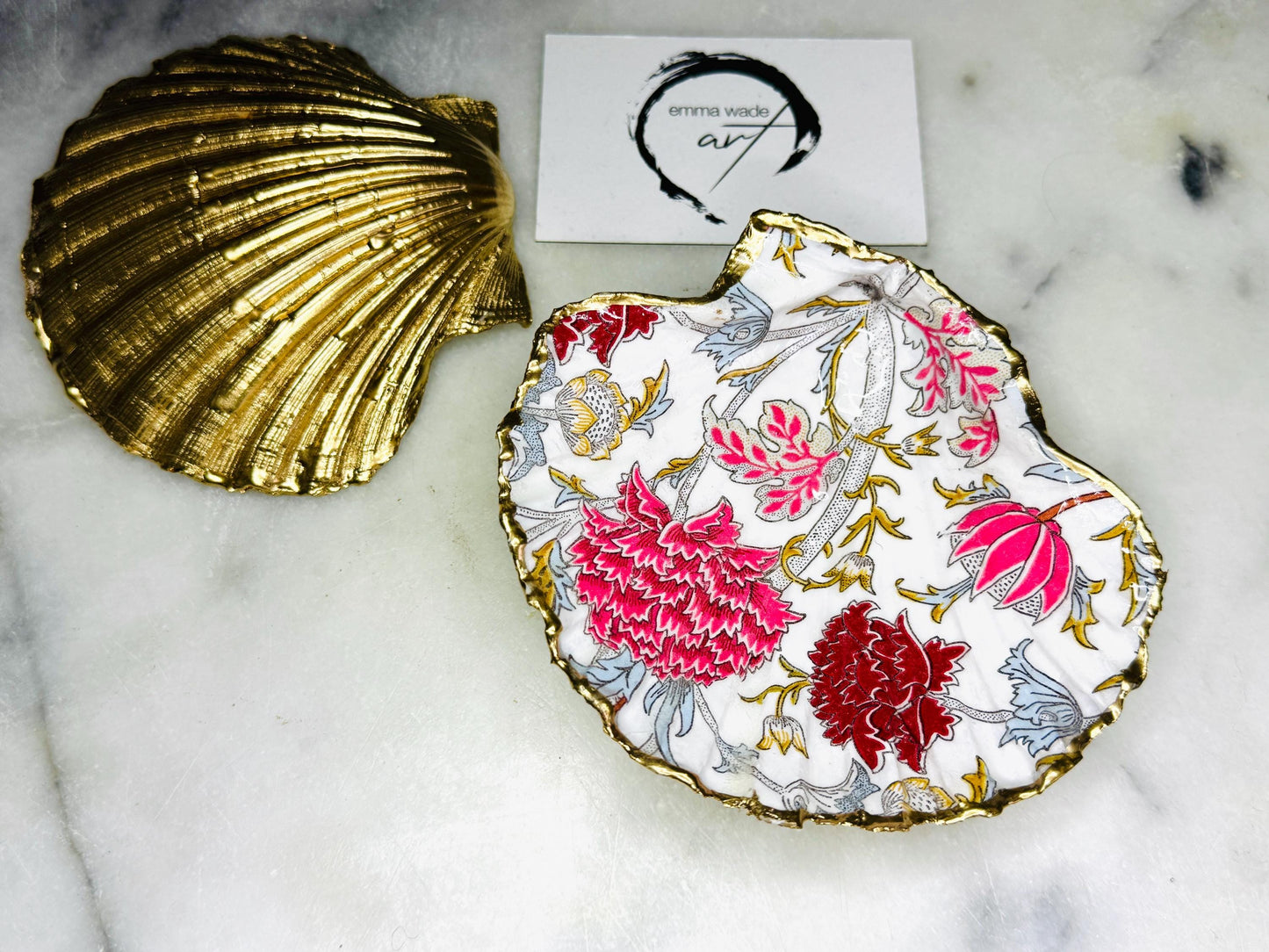 Handcrafted Dorset scallop shell trinket dish featuring William Morris Cray floral design in pink and red botanical patterns with hand gilded gold leaf edging and glossy resin finish. English cottage style jewellery dish and coastal heritage décor piece styled as a luxury shell tray.