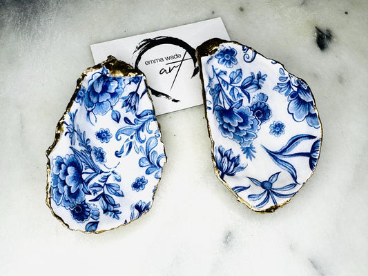 Delft blue floral oyster shell dish, handmade Dorset oyster shell trinket dish, gold leaf oyster shell jewellery holder, silver gilded oyster shell ornament, blue and white floral oyster shell decor, sustainable coastal oyster shell gift, artisan oyster shell jewellery tray UK, Delft blue oyster shell salt and pepper pinch pot, oyster shell spoon rest, handmade floral oyster shell vanity dish, Delft inspired coastal oyster shell ornament, unique oyster shell gift for wedding or anniversary