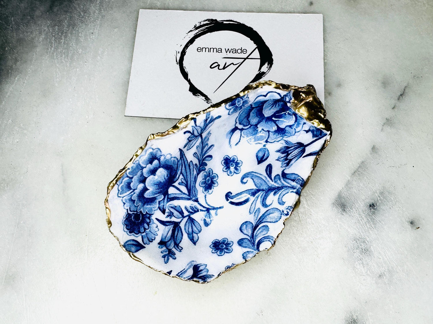 Delft blue floral oyster shell dish, handmade Dorset oyster shell trinket dish, gold leaf oyster shell jewellery holder, silver gilded oyster shell ornament, blue and white floral oyster shell decor, sustainable coastal oyster shell gift, artisan oyster shell jewellery tray UK, Delft blue oyster shell salt and pepper pinch pot, oyster shell spoon rest, handmade floral oyster shell vanity dish, Delft inspired coastal oyster shell ornament, unique oyster shell gift for wedding or anniversary