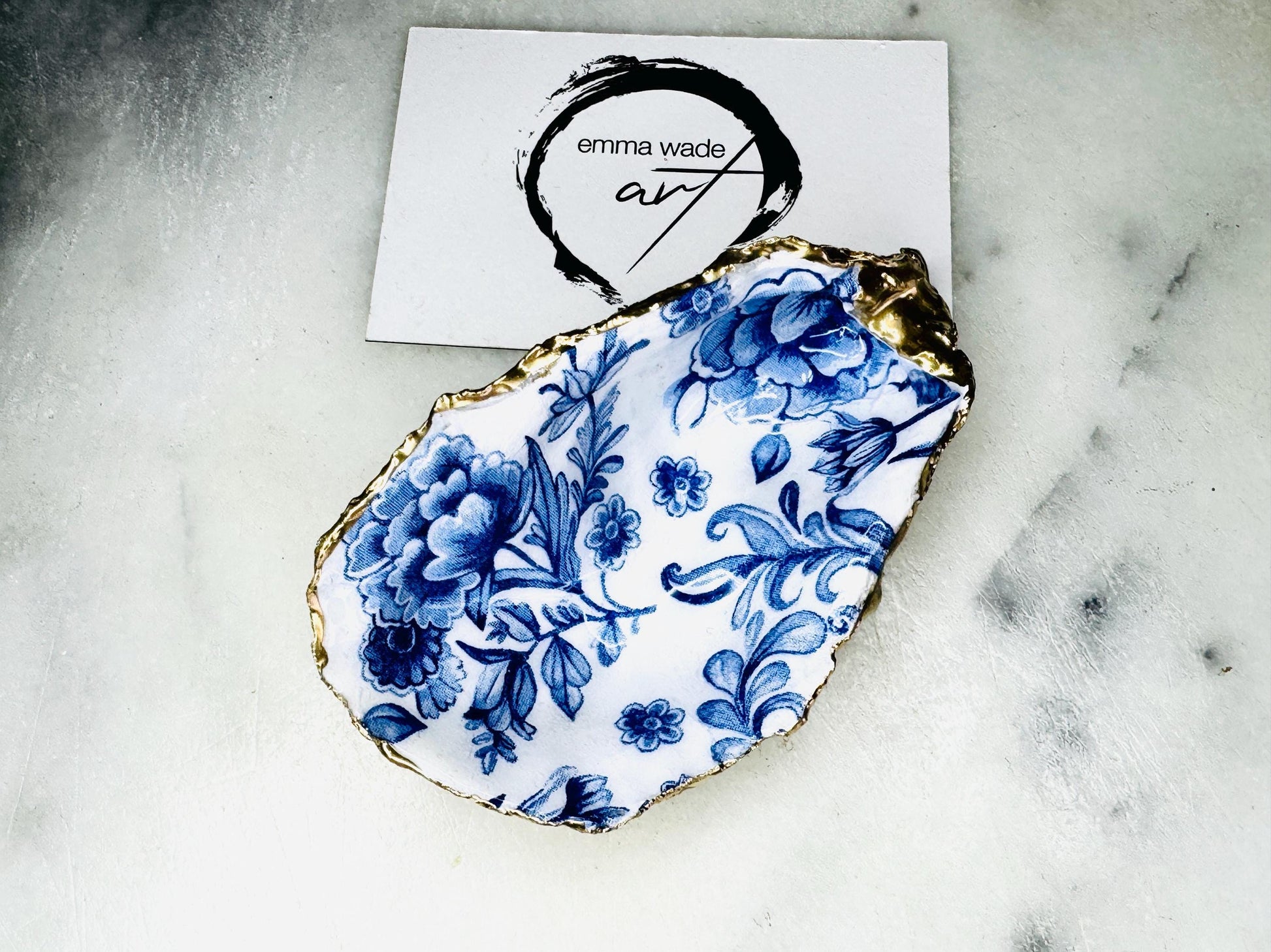 Delft blue floral oyster shell dish, handmade Dorset oyster shell trinket dish, gold leaf oyster shell jewellery holder, silver gilded oyster shell ornament, blue and white floral oyster shell decor, sustainable coastal oyster shell gift, artisan oyster shell jewellery tray UK, Delft blue oyster shell salt and pepper pinch pot, oyster shell spoon rest, handmade floral oyster shell vanity dish, Delft inspired coastal oyster shell ornament, unique oyster shell gift for wedding or anniversary