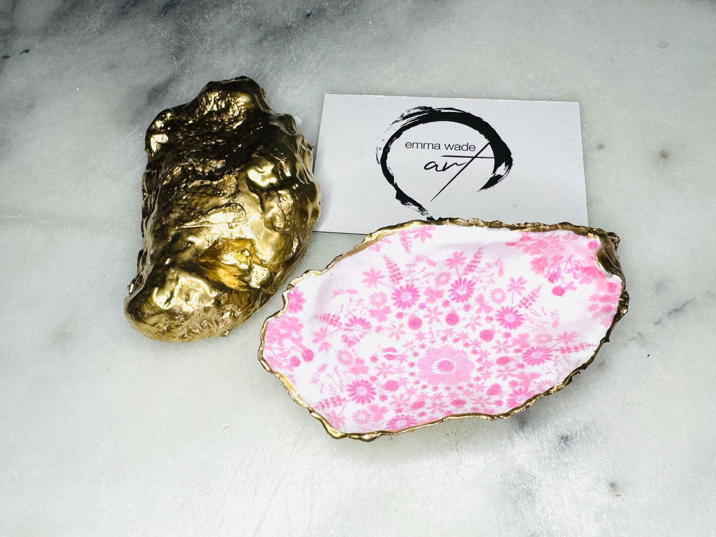 Pink lily oyster shell jewellery dish with gold leaf trim. A unique shell ring holder, trinket dish, or shell ring tray made from natural Dorset shells. Each dish has a floral design and varies slightly in size and shape. Perfect for storing rings, earrings, cufflinks, or small keepsakes. Can also be used as a tealight holder, spoon rest, or salt pinch pot. A beautiful wedding gift, bridesmaid favour, birthday present, or coastal-inspired home accessory.