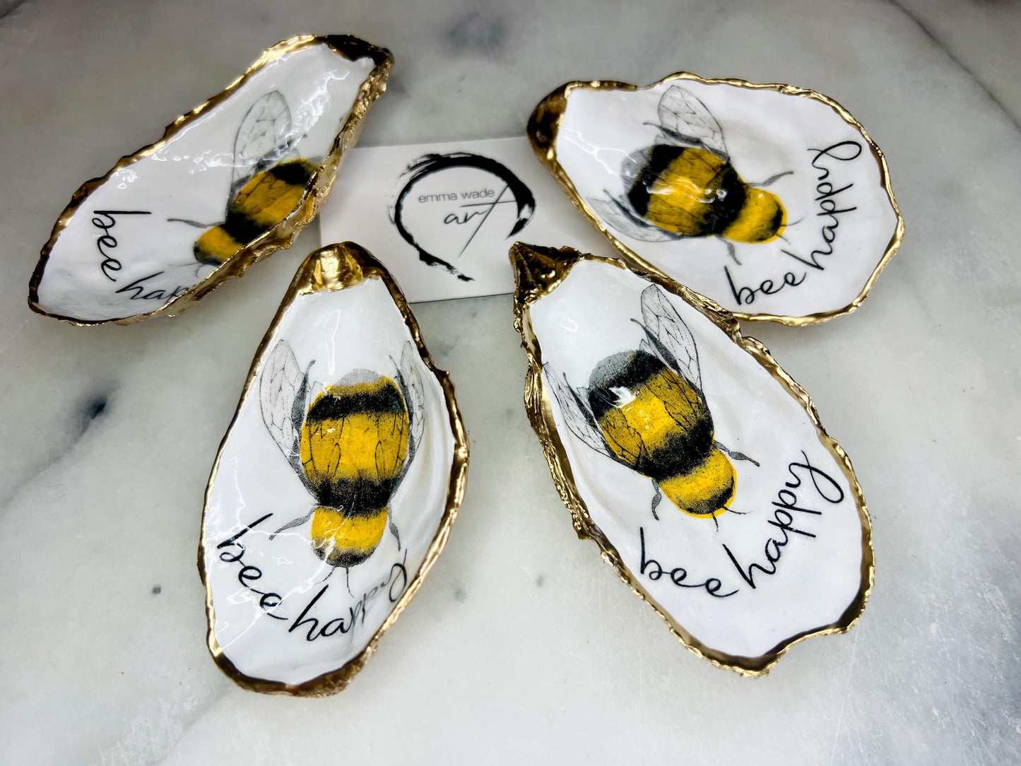 bee happy oyster shell trinket dish, Dorset oyster shell jewellery holder, handmade bee design coastal decor, gold leaf gilded oyster shell ornament, sustainable oyster shell dish UK, bumble bee oyster shell jewellery tray, nature inspired bee oyster shell gift, eco friendly oyster shell bathroom accessory, oyster shell salt and pepper pinch pot, unique bee themed oyster shell keepsake, handmade Dorset oyster shell decor, bee lover jewellery dish gift, coastal oyster shell art UK