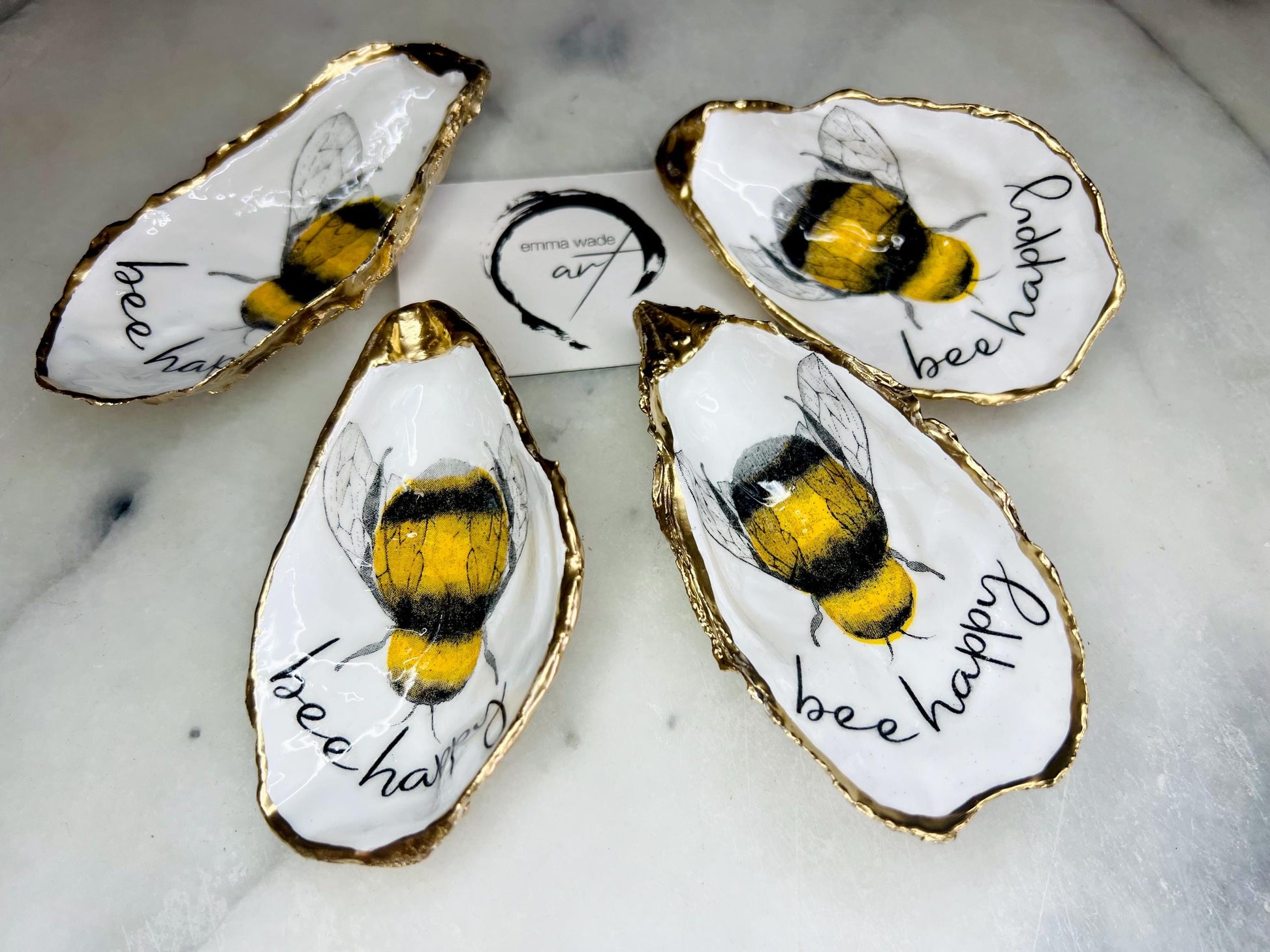 bee happy oyster shell trinket dish, Dorset oyster shell jewellery holder, handmade bee design coastal decor, gold leaf gilded oyster shell ornament, sustainable oyster shell dish UK, bumble bee oyster shell jewellery tray, nature inspired bee oyster shell gift, eco friendly oyster shell bathroom accessory, oyster shell salt and pepper pinch pot, unique bee themed oyster shell keepsake, handmade Dorset oyster shell decor, bee lover jewellery dish gift, coastal oyster shell art UK