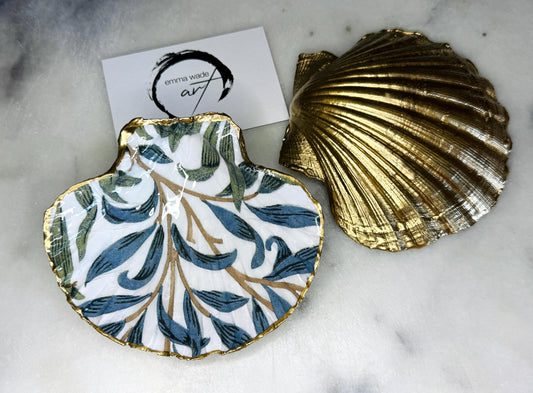 Handmade Dorset scallop shell trinket dish featuring William Morris Willow Bough design in soft blue and green tones. Decorative shell jewellery dish finished with hand-applied liquid gold leaf edging and glossy resin. Coastal inspired ring holder with botanical Arts and Crafts pattern and natural shell shape, styled as elegant bathroom décor and heritage home accessory.