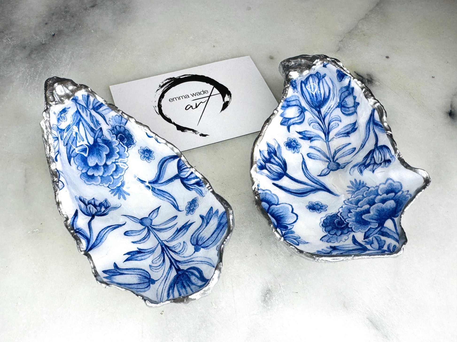 Delft blue floral oyster shell dish, handmade Dorset oyster shell trinket dish, gold leaf oyster shell jewellery holder, silver gilded oyster shell ornament, blue and white floral oyster shell decor, sustainable coastal oyster shell gift, artisan oyster shell jewellery tray UK, Delft blue oyster shell salt and pepper pinch pot, oyster shell spoon rest, handmade floral oyster shell vanity dish, Delft inspired coastal oyster shell ornament, unique oyster shell gift for wedding or anniversary