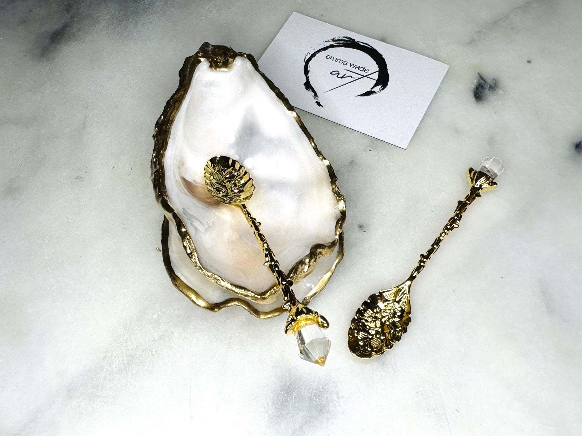 Extra large Dorset oyster shell serving dish set with natural pearl interior and hand-applied gold leaf edging, featuring a cupped XL oyster shell with matching flat shell base. Luxury coastal home décor ideal as a sugar dish, serving bowl, coffee station accessory, or elegant host gift. Handmade using sustainably sourced UK oyster shells and finished with glossy resin and optional gold serving accessories.