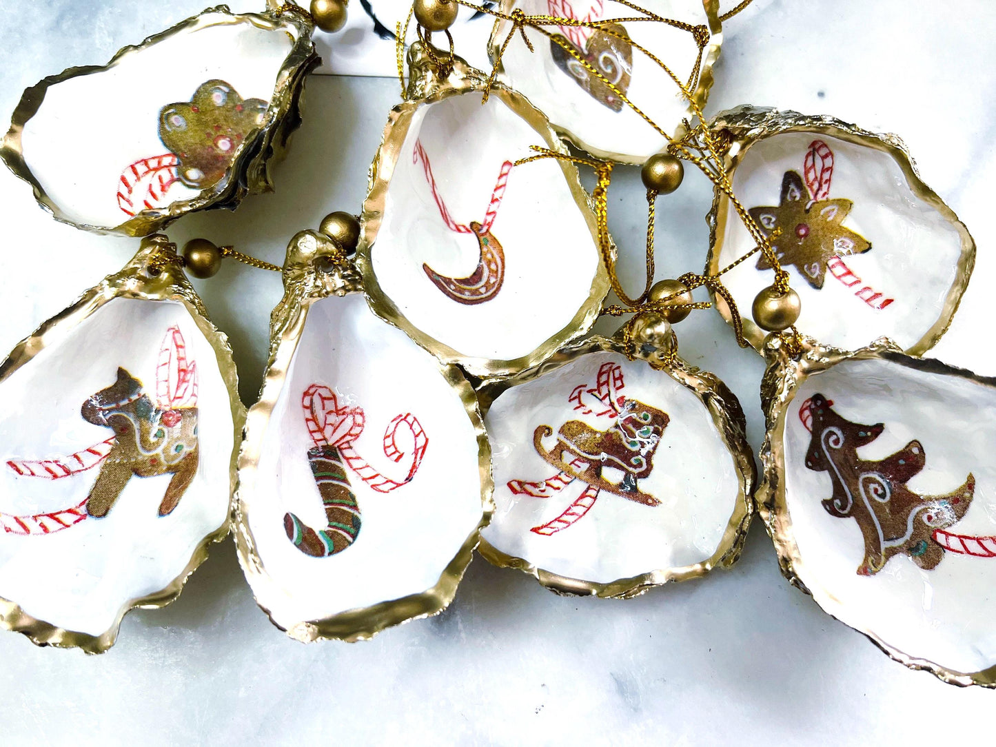 Gingerbread oyster shell ornaments, handmade Dorset Christmas tree decorations, gold leaf oyster baubles, coastal festive décor, unique oyster hanging ornaments, gingerbread candy cane shell, Christmas heart ornament, oyster star bauble, moon oyster ornament, ice skate decoration, donkey Christmas shell, cookie shell ornament, eco-friendly oyster gift, stocking filler, handmade UK holiday décor, oyster shell Christmas set.