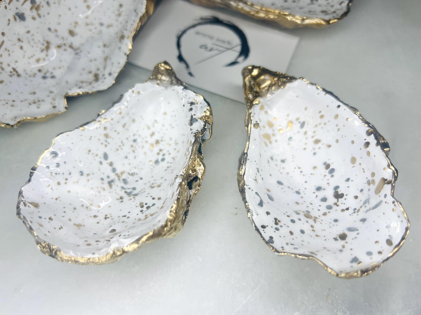 gift for her, dining decor, handmade dish, shell ornament, salt dish, salt and pepper pots, spice pots, coastal gifts, home decor, wedding favours, bridesmaid gift, pearl anniversary, shell decor, decorative accessories, EmmaWadeART, coastal decor, Handmade Dorset oyster shell salt and pepper pinch pots with glossy white interiors, speckled with liquid gold and silver leaf finish. Perfect coastal kitchen decor, beach wedding favours, or unique gift for foodies and hosts.