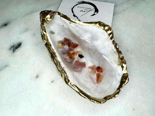 Handmade oyster shell jewellery dish with real Dorset sea glass foraged from the coast and suspended in clear glossy resin to look like a rock pool. Finished with gold leaf trim and a natural pearl interior, this unique shell dish can be used as a ring holder, jewellery tray, or trinket catcher for earrings, cufflinks, or keepsakes. A one-of-a-kind coastal-inspired gift for weddings, anniversaries, birthdays, bridesmaids, Christmas, or Mother’s Day.