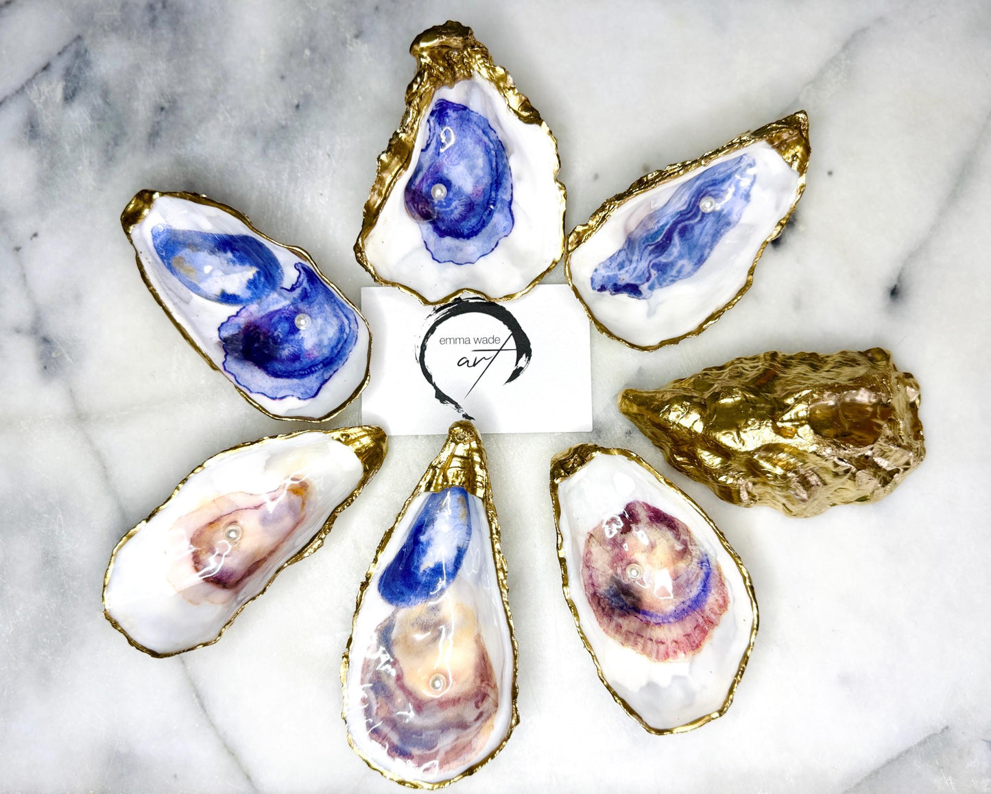 Handmade Dorset oyster shell jewellery dish with a natural pearl finish, gilded with liquid gold leaf and sealed in glossy resin. Each oyster shell features a Swarovski pearl inside, making it a unique ring holder, trinket tray, or coastal-inspired jewellery organiser. Perfect as a handmade oyster ring dish for weddings, anniversaries, birthdays, or as a bridesmaid gift. A one-of-a-kind shell catchall tray, ideal for coastal home décor or thoughtful handmade presents.