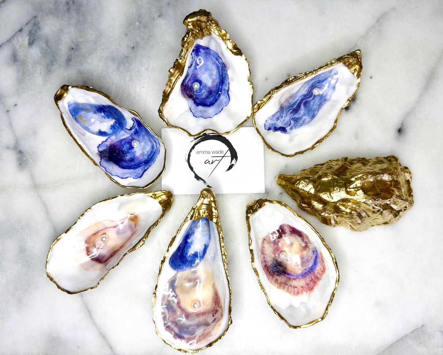 Handmade Dorset oyster shell jewellery dish with a natural pearl finish, gilded with liquid gold leaf and sealed in glossy resin. Each oyster shell features a Swarovski pearl inside, making it a unique ring holder, trinket tray, or coastal-inspired jewellery organiser. Perfect as a handmade oyster ring dish for weddings, anniversaries, birthdays, or as a bridesmaid gift. A one-of-a-kind shell catchall tray, ideal for coastal home décor or thoughtful handmade presents.