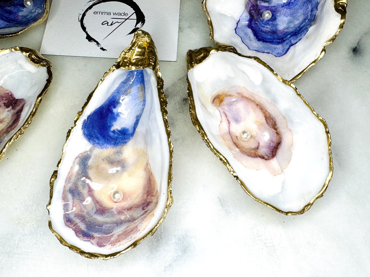 Handmade Dorset oyster shell jewellery dish with a natural pearl finish, gilded with liquid gold leaf and sealed in glossy resin. Each oyster shell features a Swarovski pearl inside, making it a unique ring holder, trinket tray, or coastal-inspired jewellery organiser. Perfect as a handmade oyster ring dish for weddings, anniversaries, birthdays, or as a bridesmaid gift. A one-of-a-kind shell catchall tray, ideal for coastal home décor or thoughtful handmade presents.