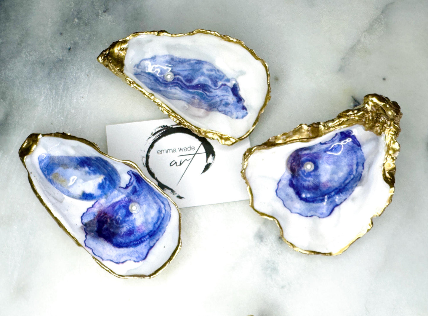 Handmade Dorset oyster shell jewellery dish with a natural pearl finish, gilded with liquid gold leaf and sealed in glossy resin. Each oyster shell features a Swarovski pearl inside, making it a unique ring holder, trinket tray, or coastal-inspired jewellery organiser. Perfect as a handmade oyster ring dish for weddings, anniversaries, birthdays, or as a bridesmaid gift. A one-of-a-kind shell catchall tray, ideal for coastal home décor or thoughtful handmade presents.