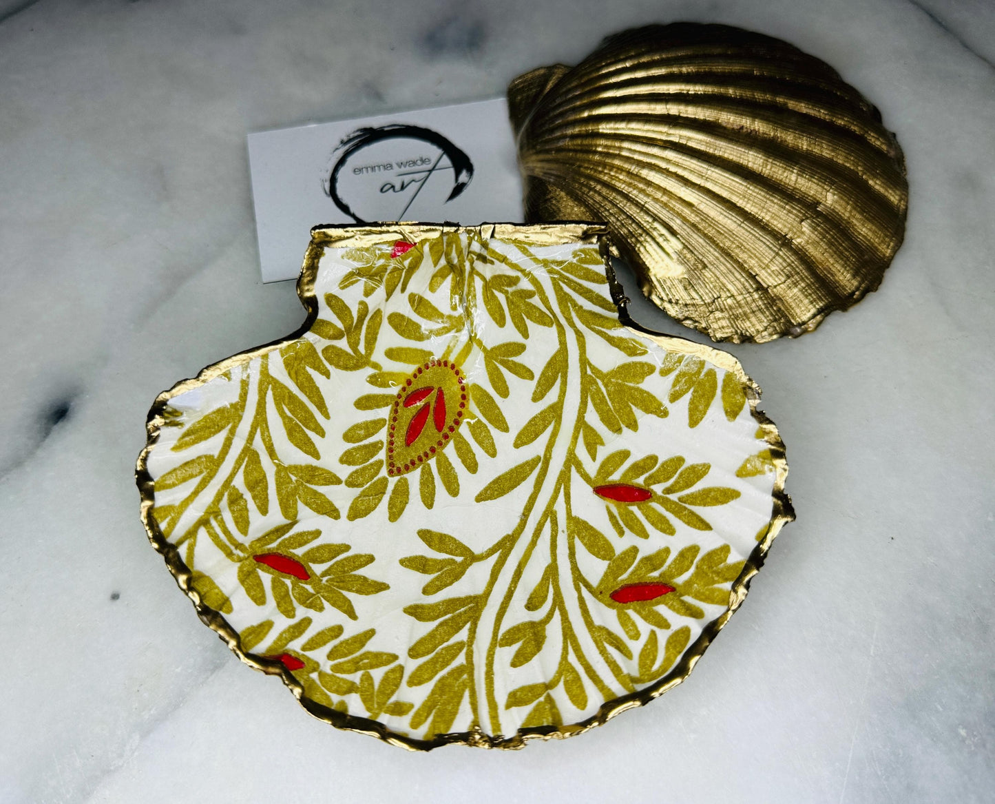 Elegant red and gold floral scallop shell trinket dish, hand-painted and gilded with liquid gold leaf before being sealed in crystal-clear resin. Each shell is a one-of-a-kind Dorset creation, perfect as a jewellery holder, tea light dish, or coastal home décor accent. A beautiful handmade ocean-inspired gift, presented in eco-friendly packaging and finished with sustainable care and artistry