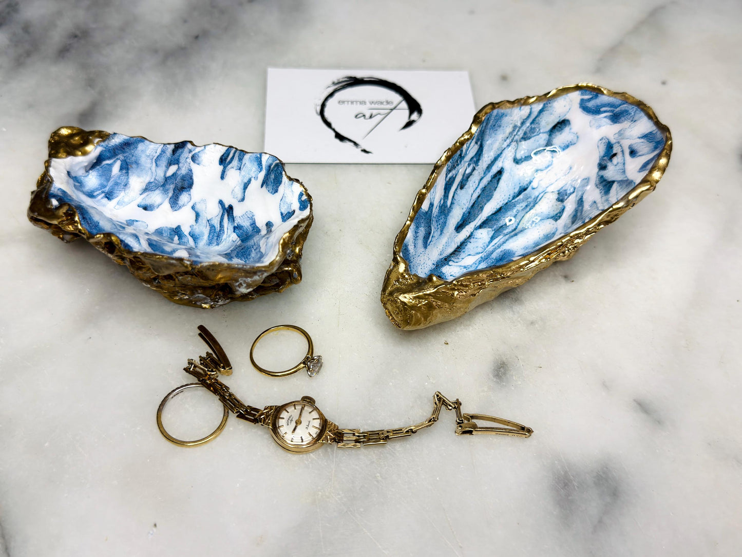 Handcrafted Dorset oyster shell trinket dish featuring blue seaweed design | Gilded with liquid gold leaf and sealed with clear resin | Perfect as a jewellery dish, ring holder, or decorative coastal ornament | Optional gold antler stand available | Each shell is sustainably sourced and hand finished with unique natural variations | Ideal ocean-inspired gift for weddings, anniversaries, birthdays, or home decor
