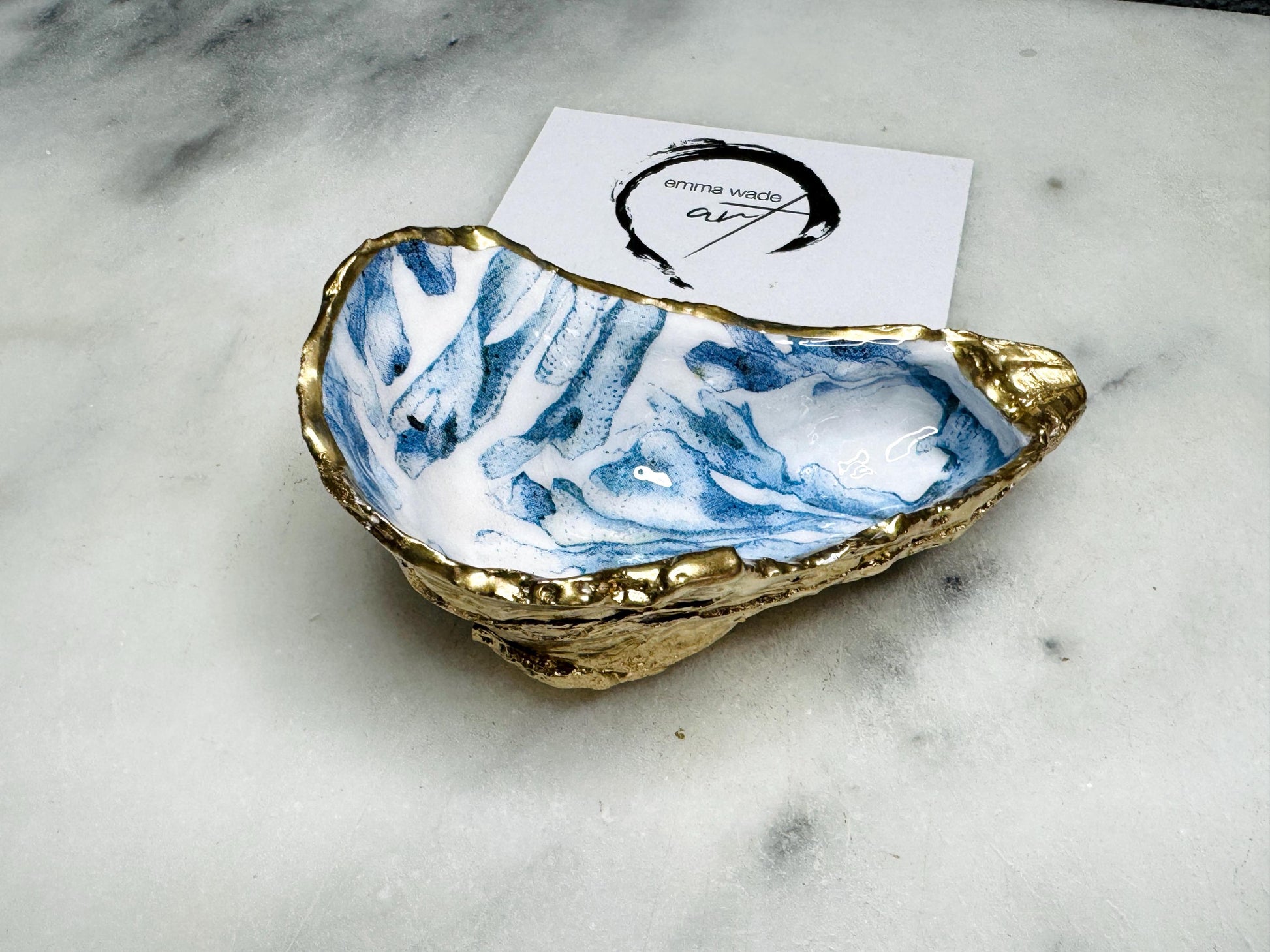 Handcrafted Dorset oyster shell trinket dish featuring blue seaweed design | Gilded with liquid gold leaf and sealed with clear resin | Perfect as a jewellery dish, ring holder, or decorative coastal ornament | Optional gold antler stand available | Each shell is sustainably sourced and hand finished with unique natural variations | Ideal ocean-inspired gift for weddings, anniversaries, birthdays, or home decor