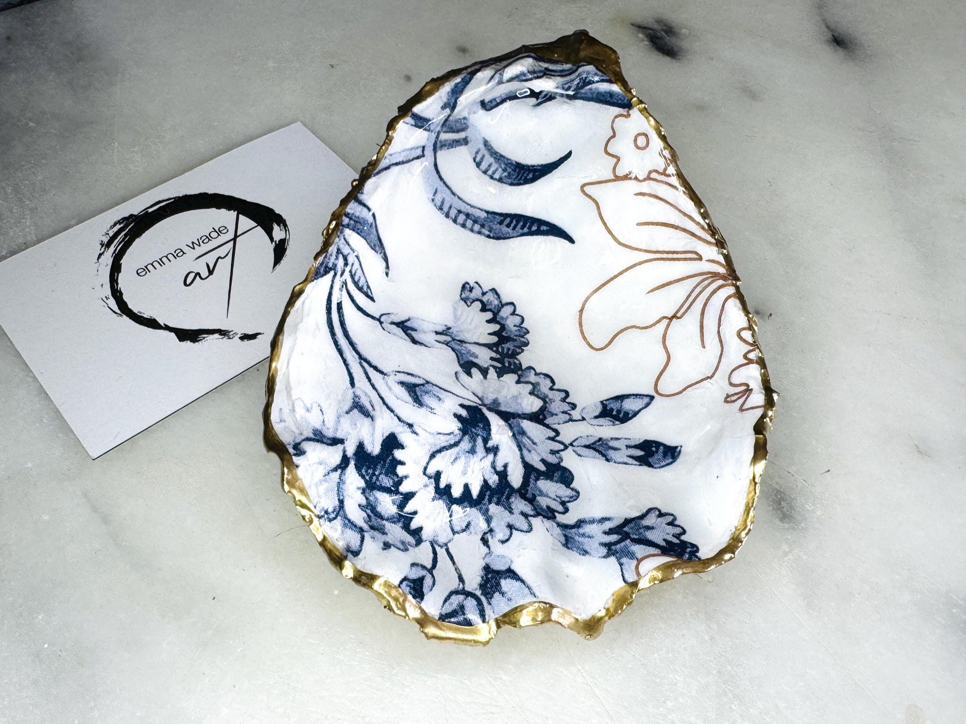blue white Palmers print oyster shell dish, Dorset oyster shell trinket dish, gold leaf gilded oyster shell jewellery holder, handmade coastal oyster shell decor, sustainable oyster shell ornament, oyster shell bathroom tray, oyster shell salt and pepper pinch pot, oyster shell sugar dish, oyster shell spoon rest, floral oyster shell wedding gift, oyster shell Christmas present, eco friendly oyster shell art, oyster shell keepsake, unique handmade oyster shell gift UK