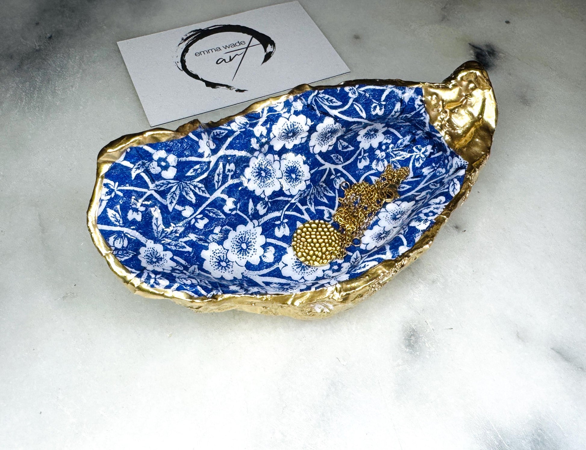 navy blue and white floral oyster shell dish, Dorset oyster shell jewellery holder, handmade coastal trinket dish UK, gold leaf gilded oyster shell ornament, eco friendly oyster shell vanity tray, unique handmade oyster shell cufflink or tie pin dish, navy floral oyster shell salt and pepper pinch pot, oyster shell spoon rest or sugar dish, floral oyster shell coastal bathroom accessory, sustainable Dorset oyster shell art, handmade oyster shell wedding or anniversary gift UK
