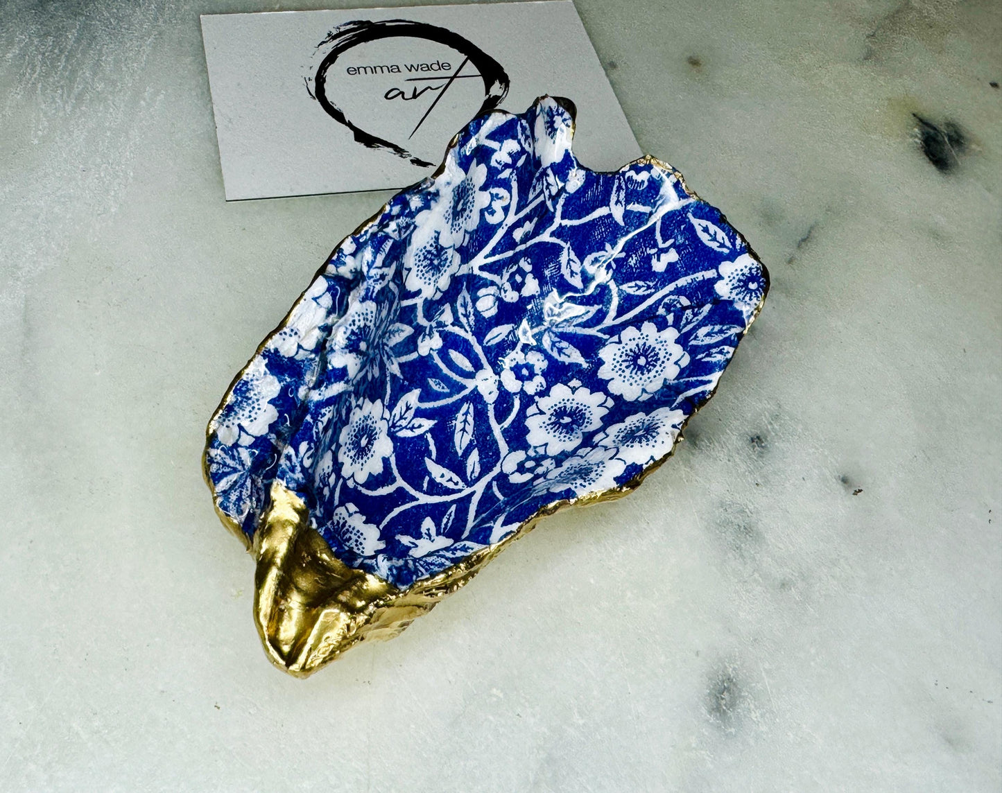navy blue and white floral oyster shell dish, Dorset oyster shell jewellery holder, handmade coastal trinket dish UK, gold leaf gilded oyster shell ornament, eco friendly oyster shell vanity tray, unique handmade oyster shell cufflink or tie pin dish, navy floral oyster shell salt and pepper pinch pot, oyster shell spoon rest or sugar dish, floral oyster shell coastal bathroom accessory, sustainable Dorset oyster shell art, handmade oyster shell wedding or anniversary gift UK