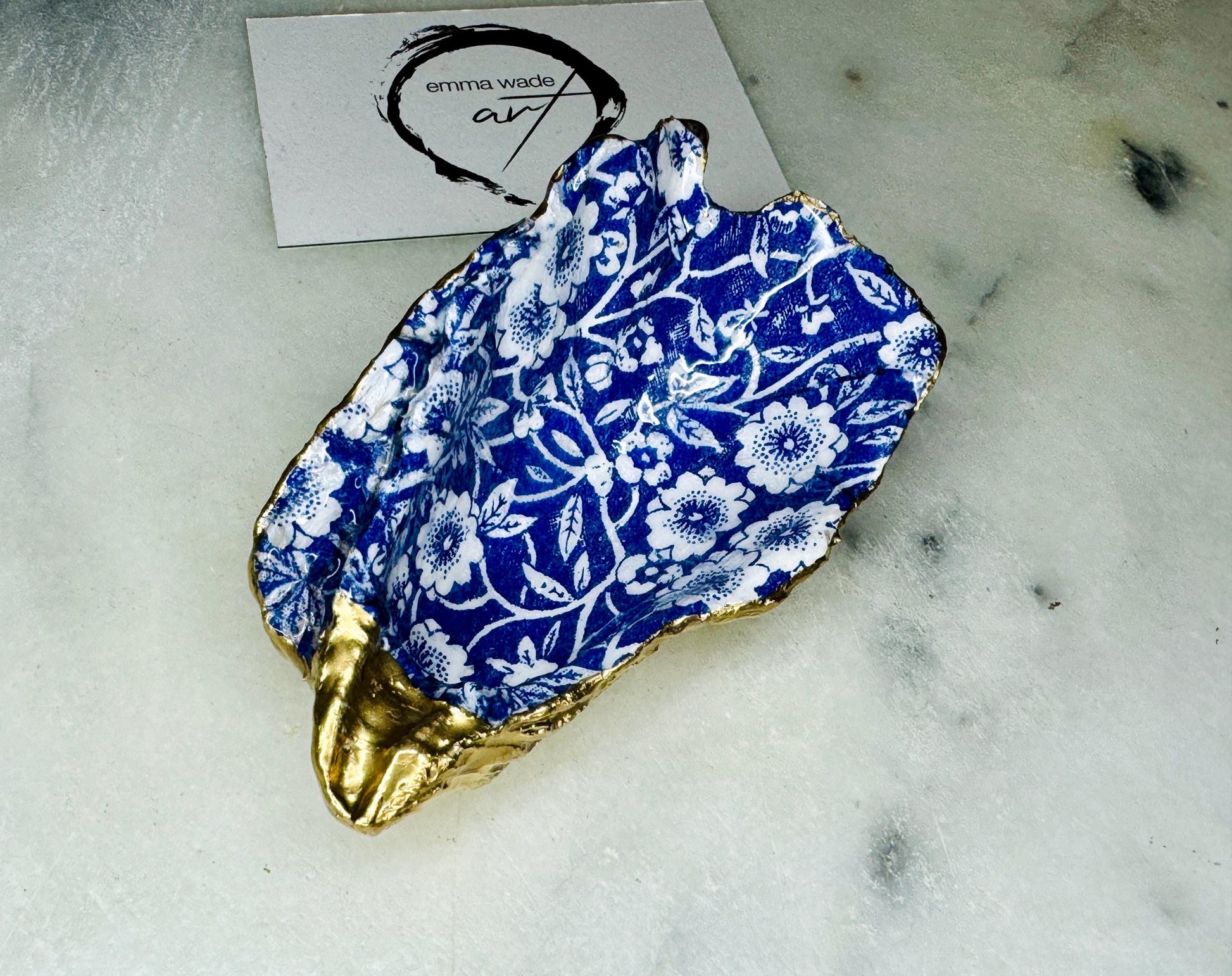 navy blue and white floral oyster shell dish, Dorset oyster shell jewellery holder, handmade coastal trinket dish UK, gold leaf gilded oyster shell ornament, eco friendly oyster shell vanity tray, unique handmade oyster shell cufflink or tie pin dish, navy floral oyster shell salt and pepper pinch pot, oyster shell spoon rest or sugar dish, floral oyster shell coastal bathroom accessory, sustainable Dorset oyster shell art, handmade oyster shell wedding or anniversary gift UK