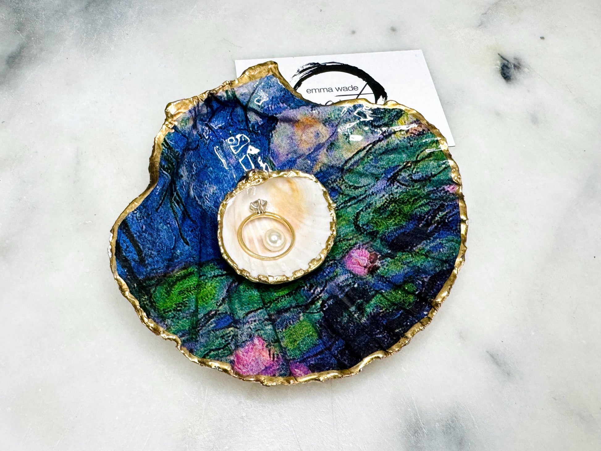 Claude Monet Waterlilies inspired shell dish set featuring a scallop trinket dish and cockle ring holder | Decorated with blue and pink floral waterlilies | Gilded with real gold leaf and sealed in high gloss resin | Perfect as a wedding ring tray, jewellery dish, or vanity display | Handmade in Dorset from sustainably sourced shells | A coastal art-inspired gift for weddings, birthdays, or anniversaries