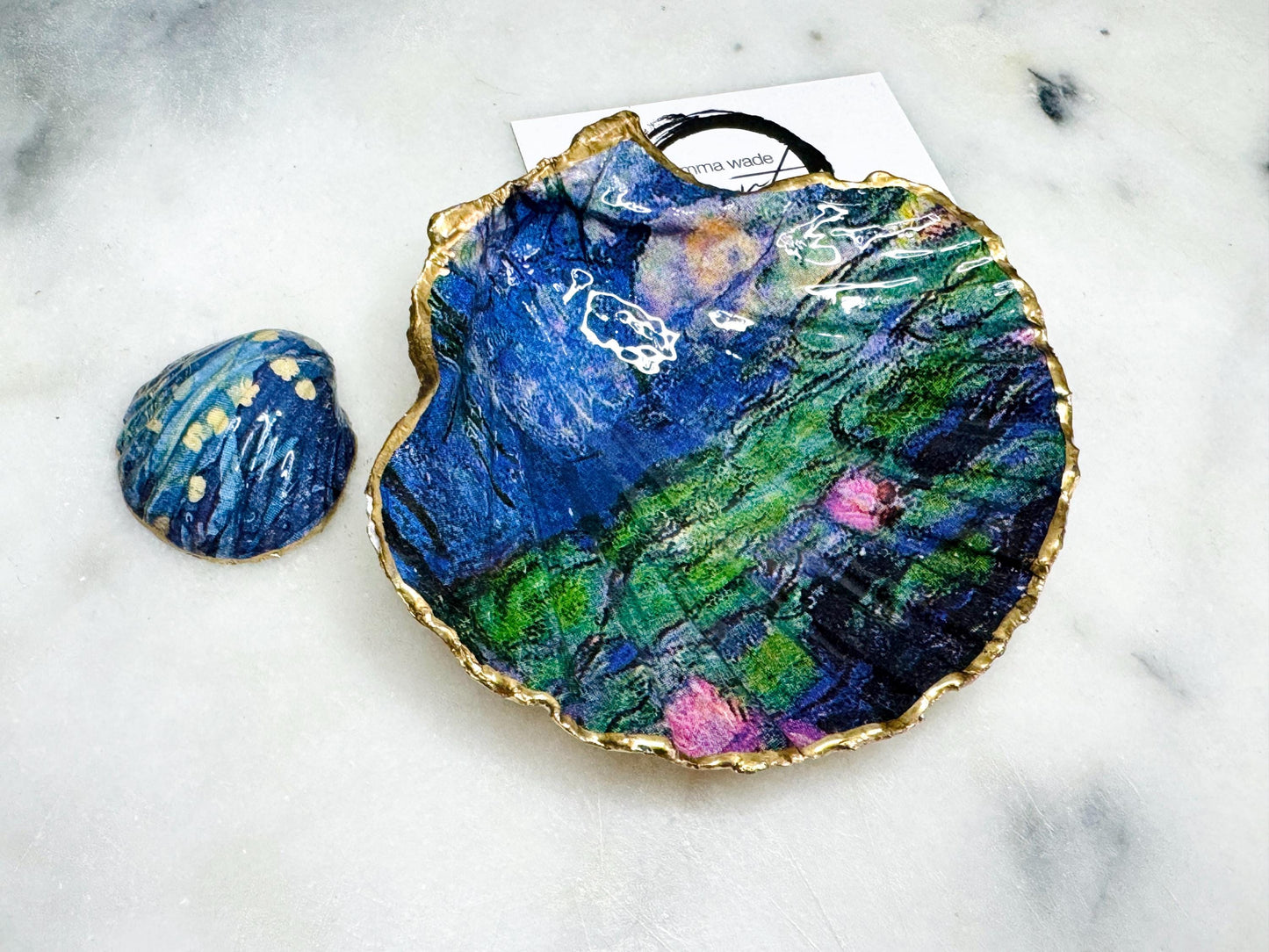 Claude Monet Waterlilies inspired shell dish set featuring a scallop trinket dish and cockle ring holder | Decorated with blue and pink floral waterlilies | Gilded with real gold leaf and sealed in high gloss resin | Perfect as a wedding ring tray, jewellery dish, or vanity display | Handmade in Dorset from sustainably sourced shells | A coastal art-inspired gift for weddings, birthdays, or anniversaries